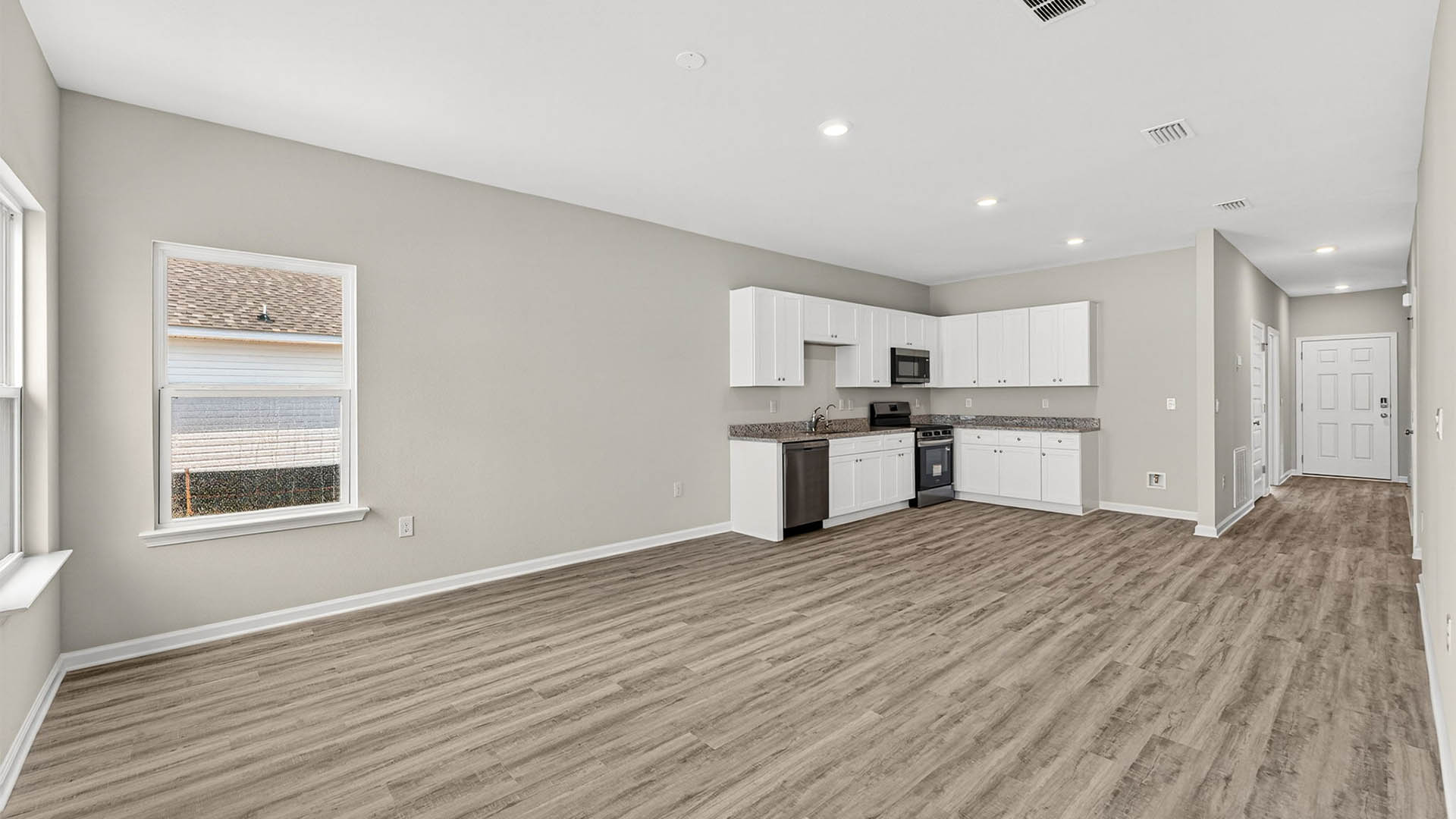 Open living room and kitchen with EVP flooring.