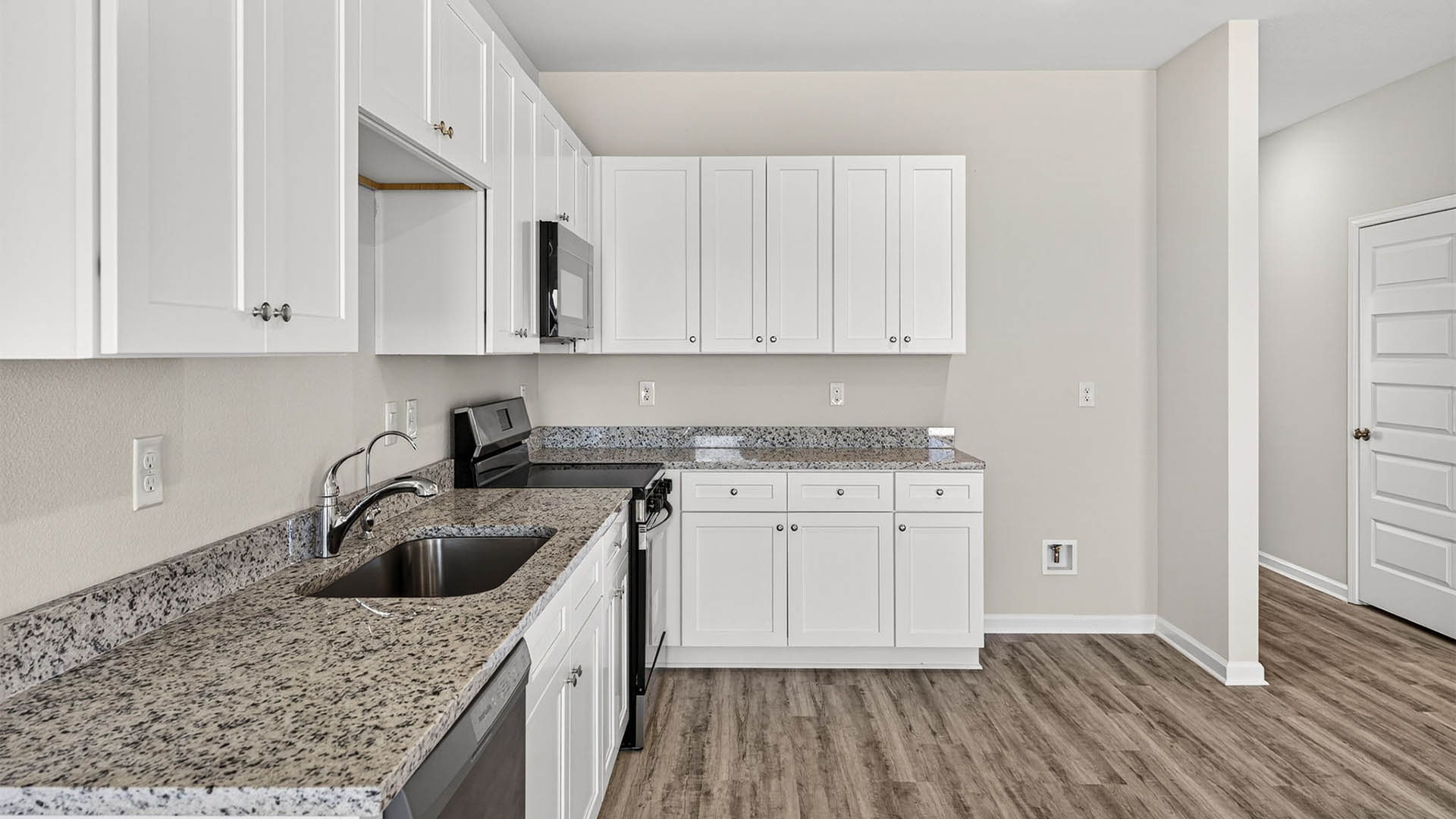 Kitchen with granite countertops and stainless-steel appliances.