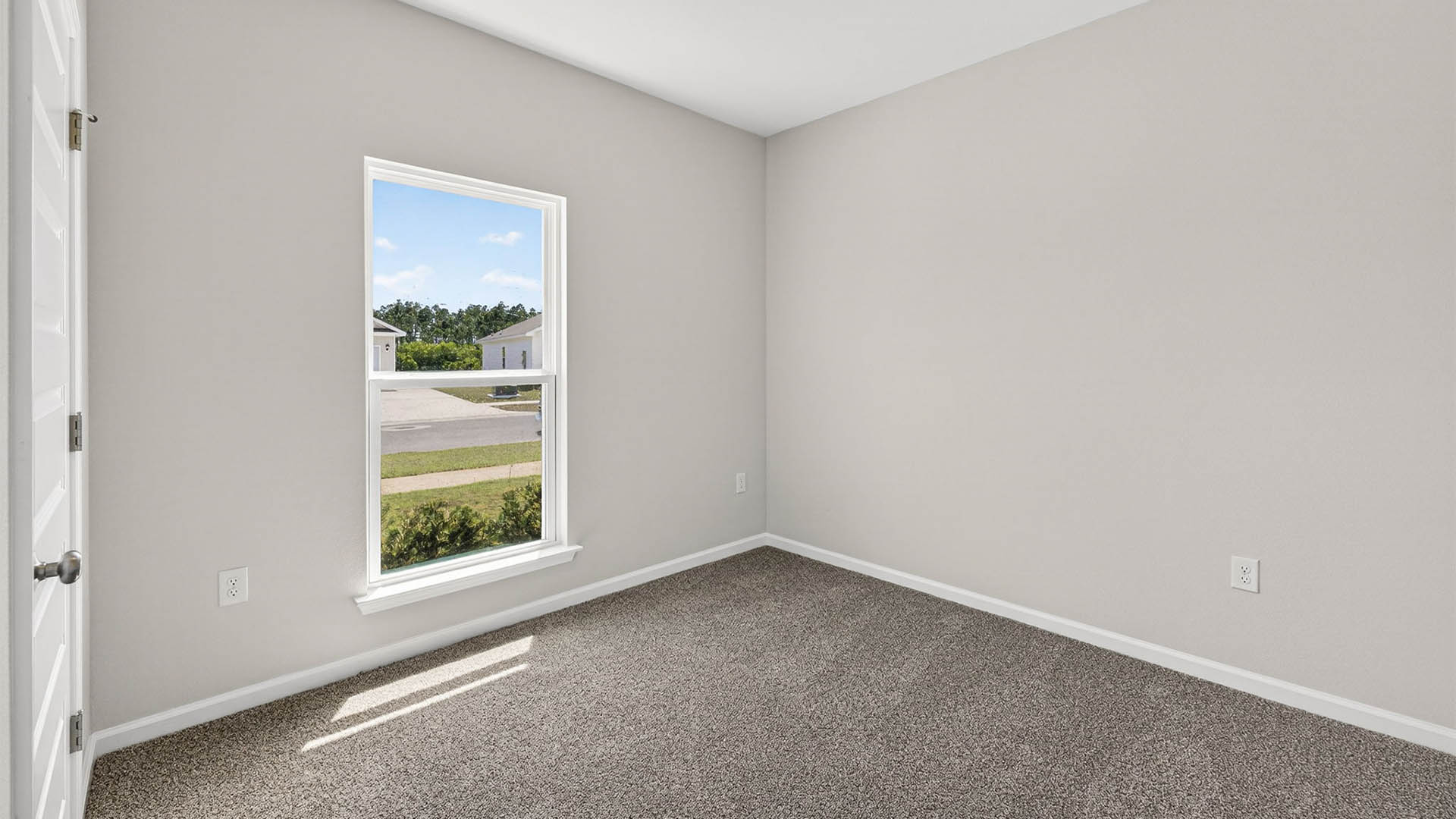 Bedroom with carpet floor and window.