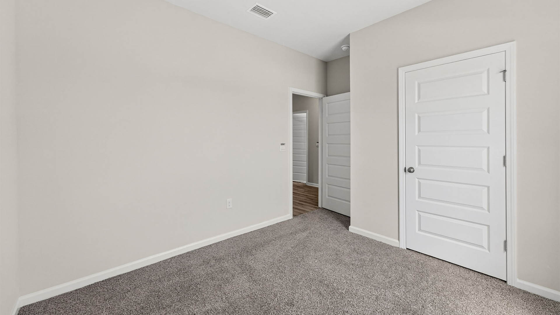 Bedroom with carpet floor and closet.