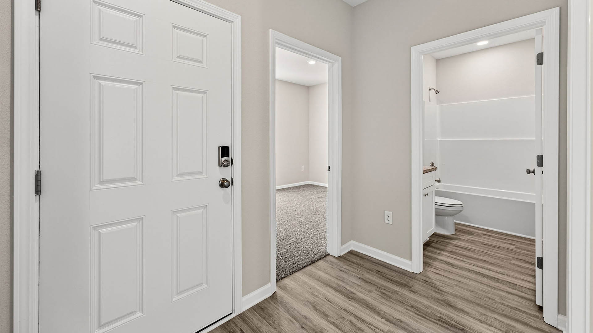 Hallway next to bedrooms and bathroom and front door.