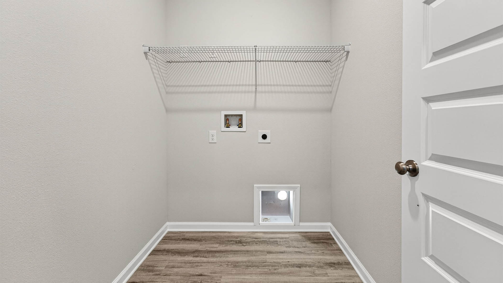 Laundry room with EVP flooring and shelving.