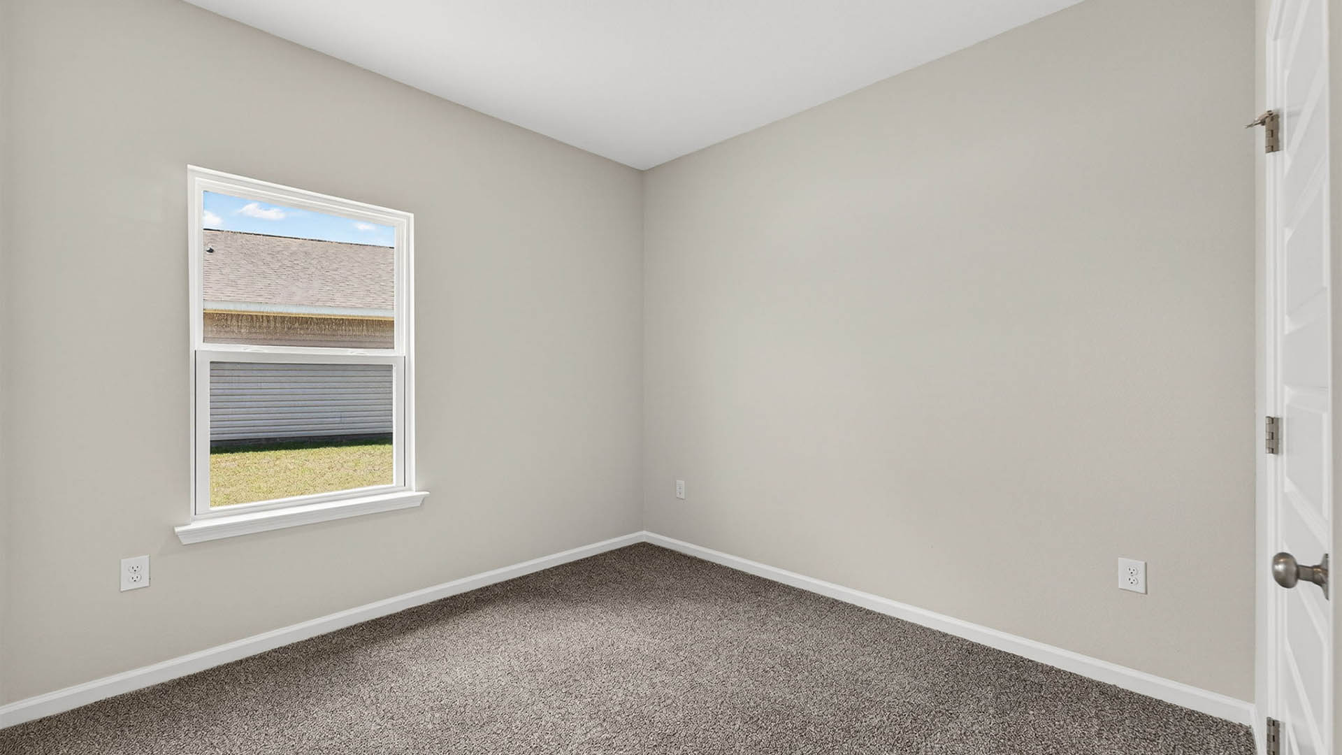 Bedroom with carpet floor and window.