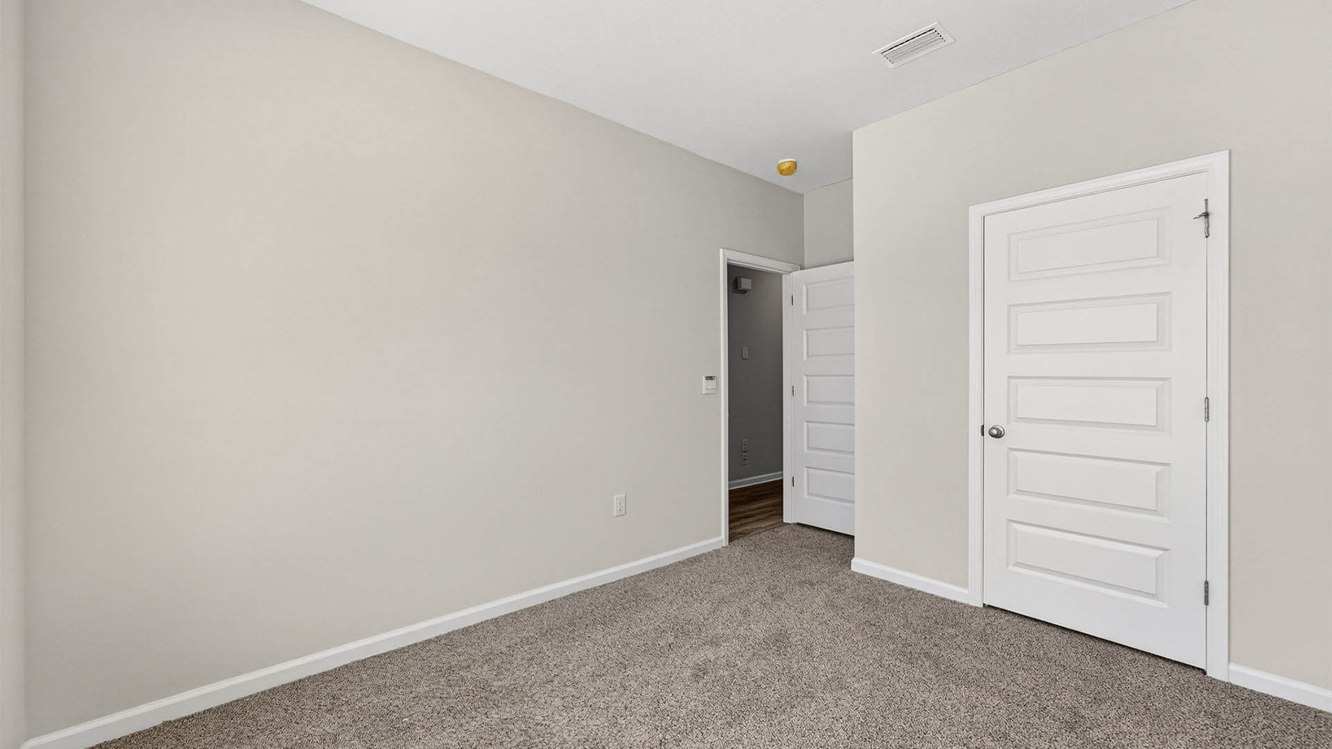 Bedroom with carpet floor and closet.