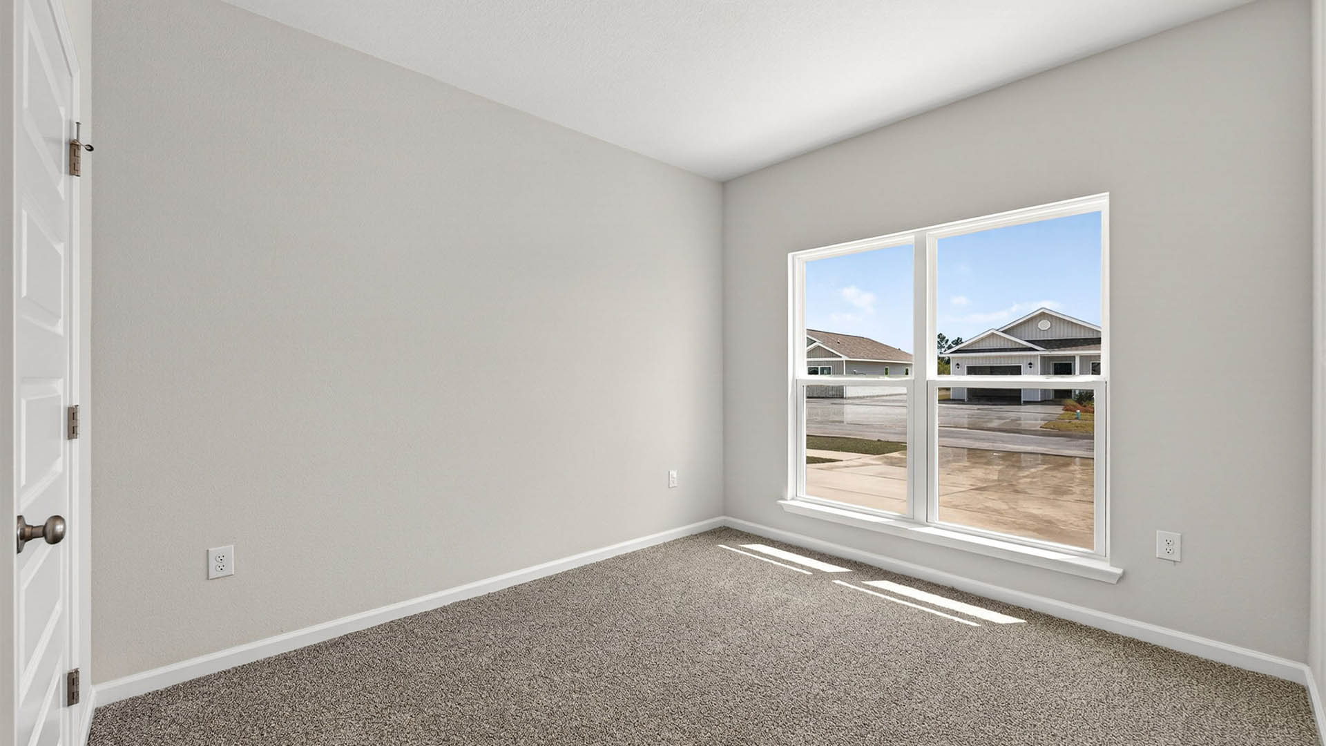 Bedroom with carpet floor and window.