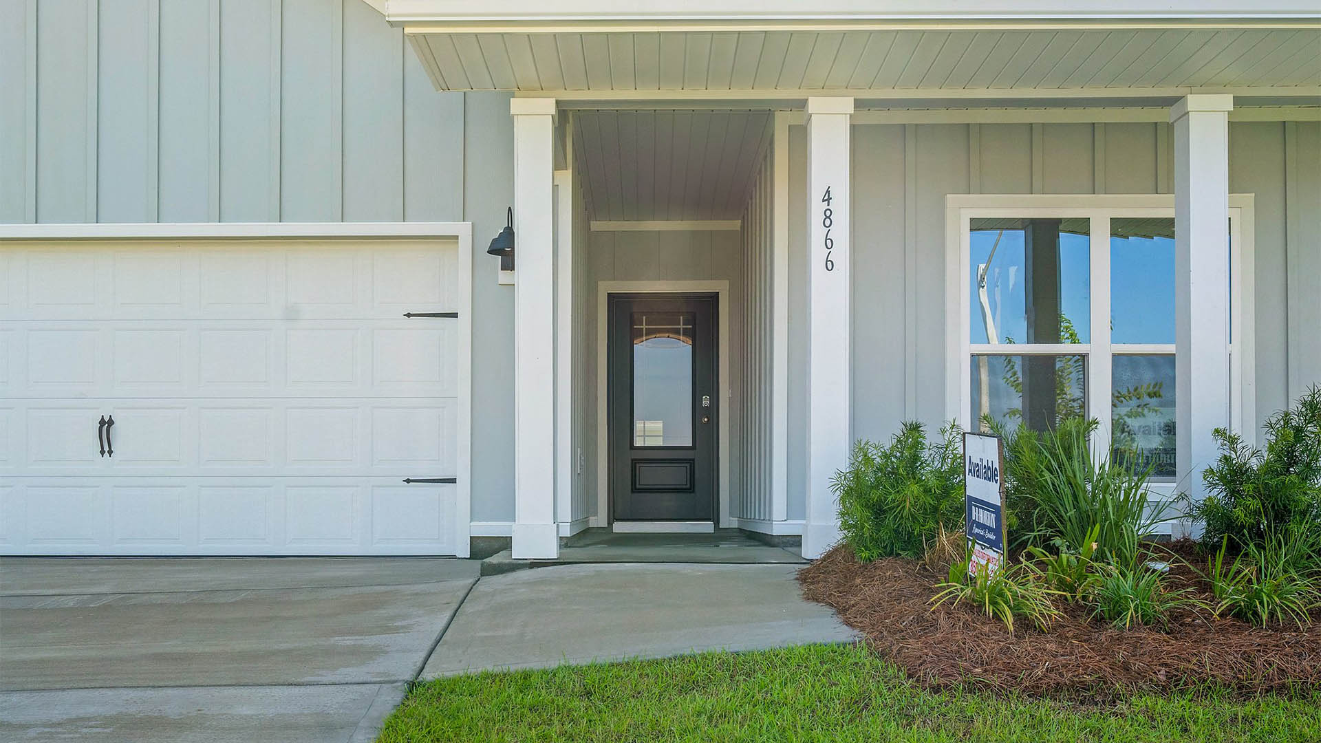 Delray floor plan at Titus Park front of home with two car garage.
