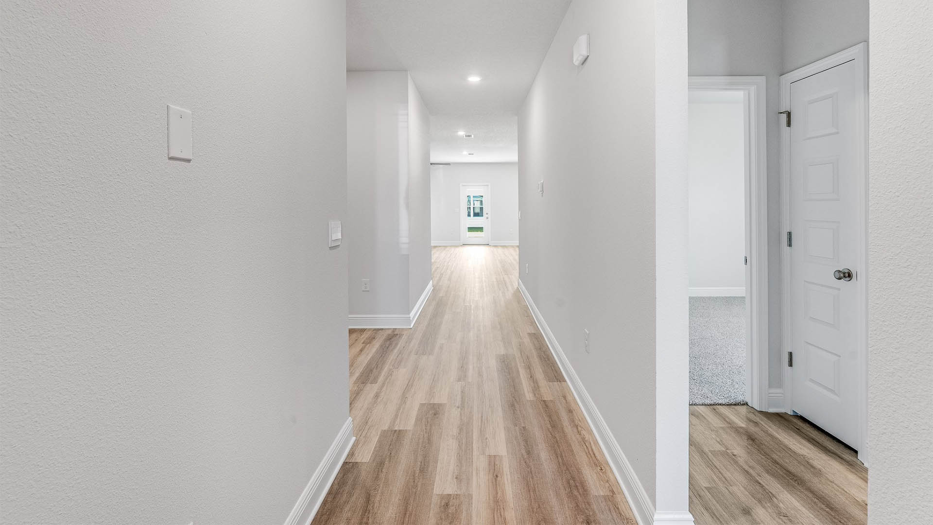 Front entrance with EVP flooring next to bedrooms and bathroom.