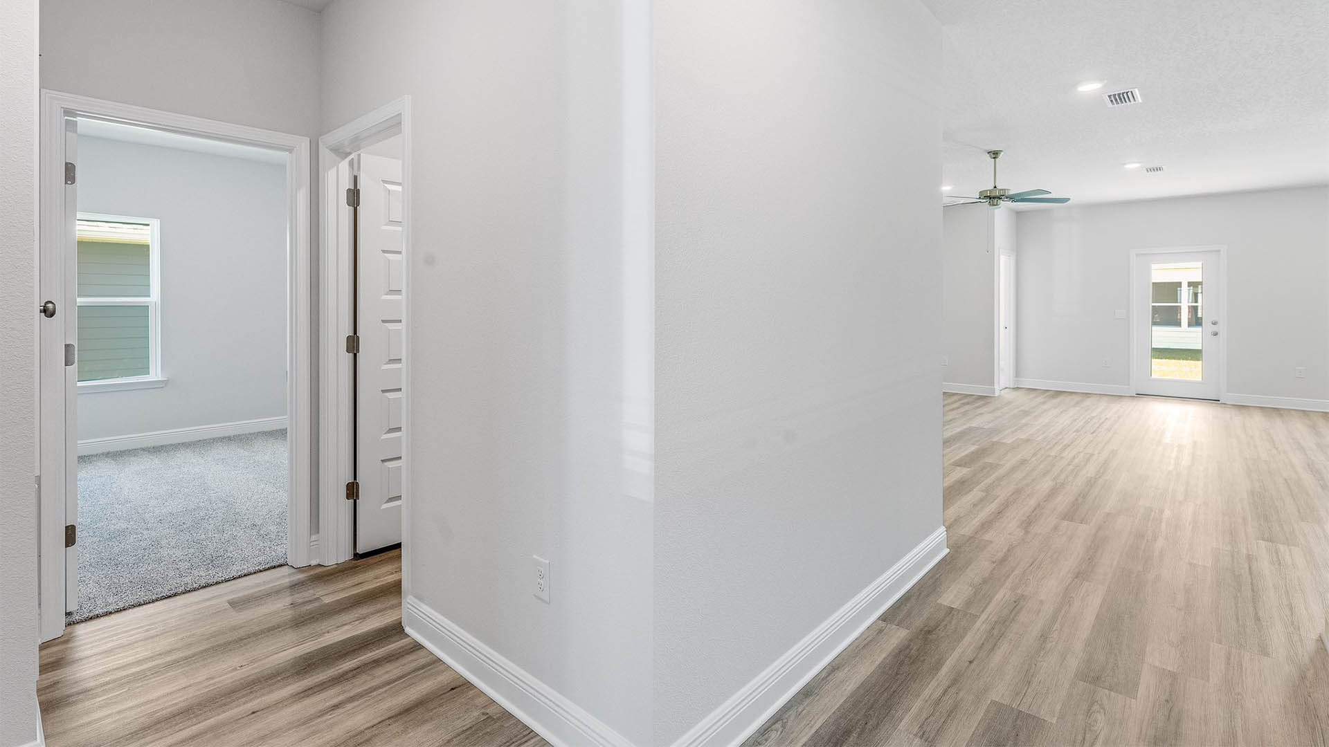 Hallway by bedroom and laundry room and garage with EVP flooring.