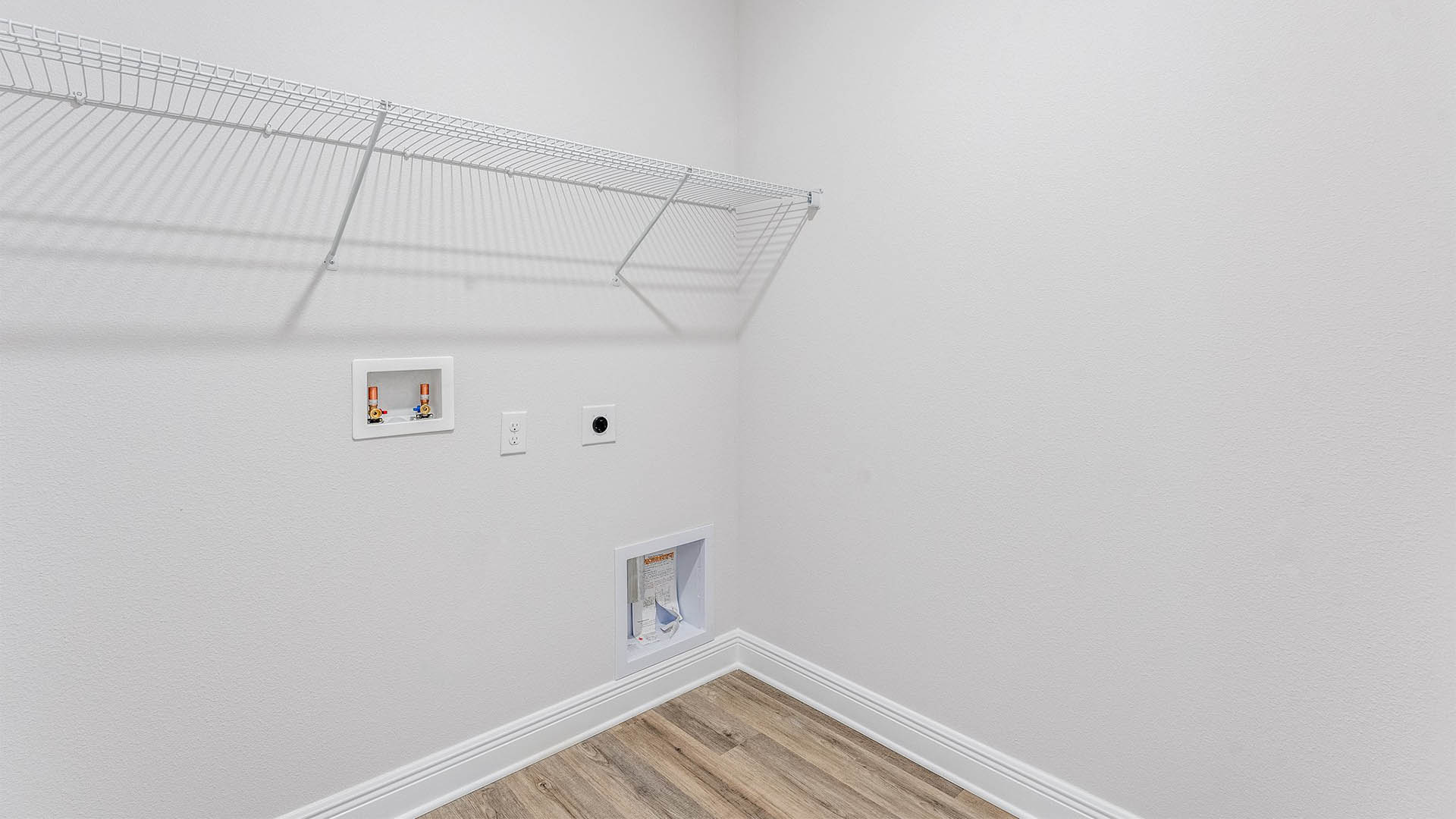 Laundry room with EVP flooring and ventilated shelving.