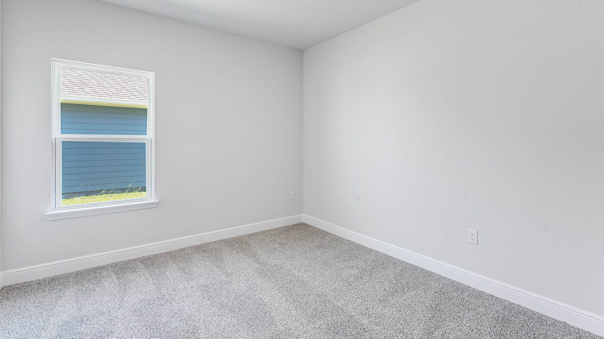 Bedroom with carpet floors and window.