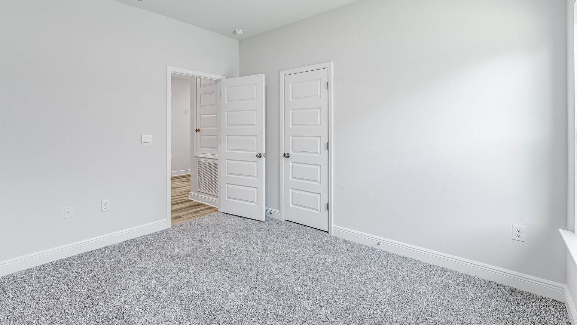 Bedroom with carpet floors and closet.