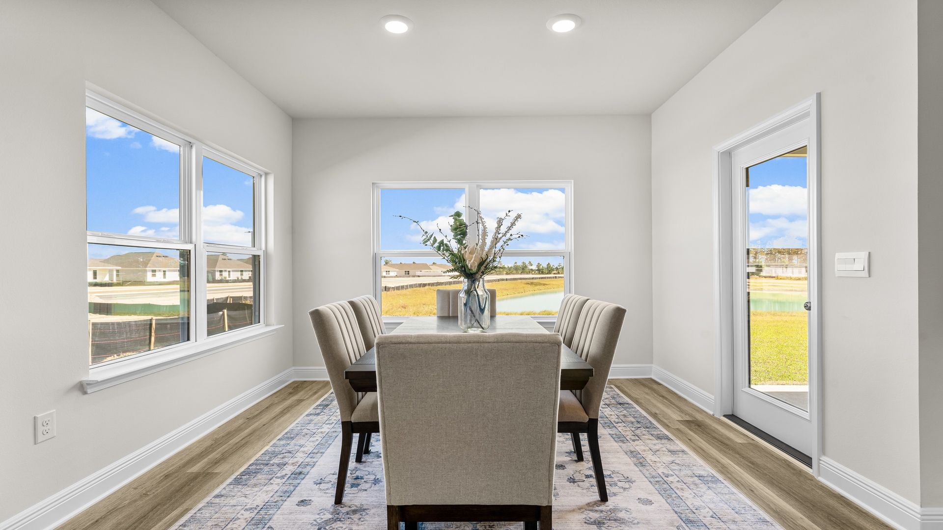 Dining area with double windows and prairie style back door and EVP flooring.