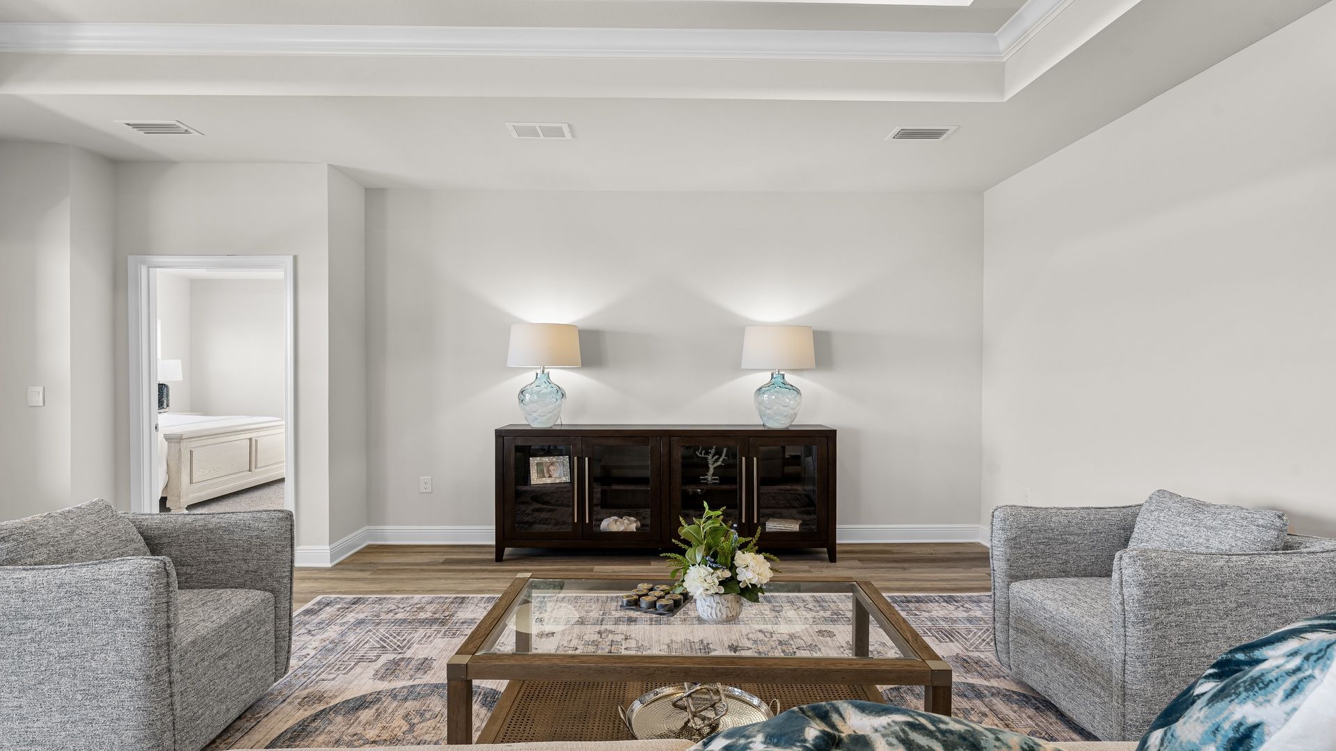 Open living room with EVP flooring and tray ceilings.