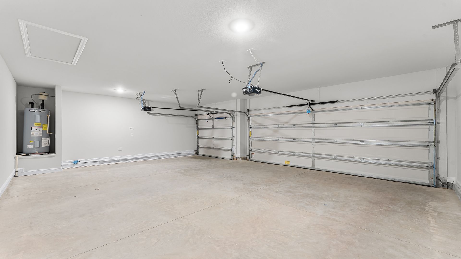 Three-car garage with water heater.