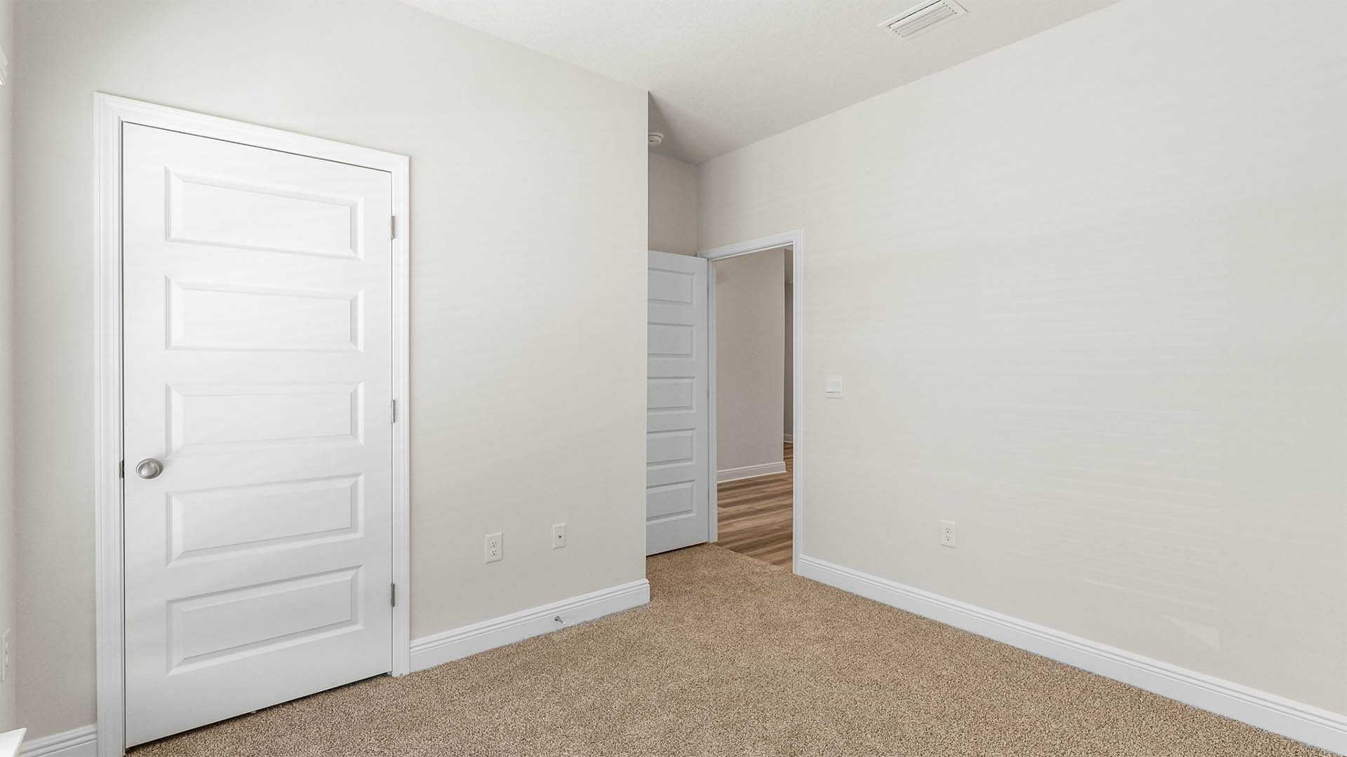 Bedroom with carpet floors and closet.