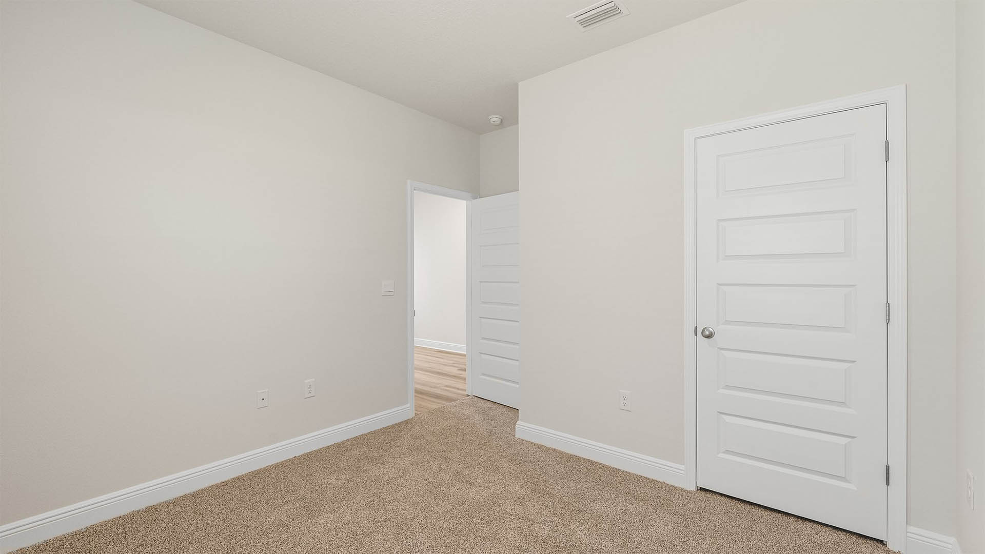 Bedroom with carpet floors and closet.