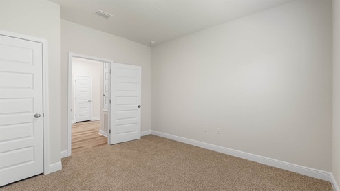 Bedroom with carpet floors and closet.