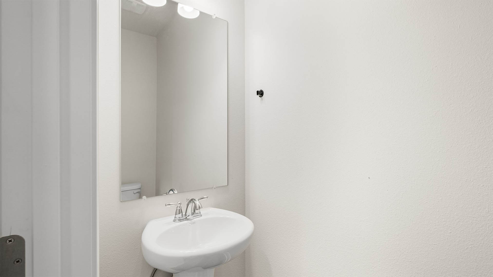 Bathroom with single vanity and toilet.