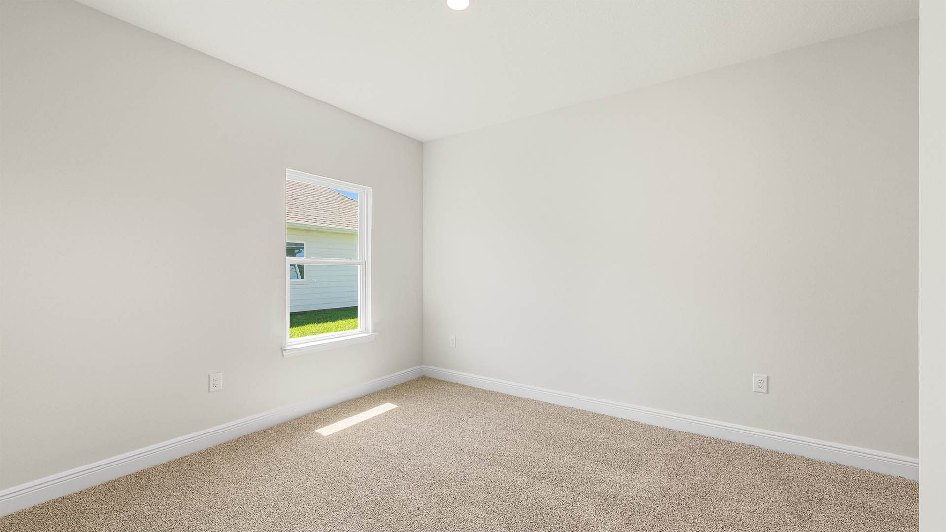 Bedroom with carpet floors and window.