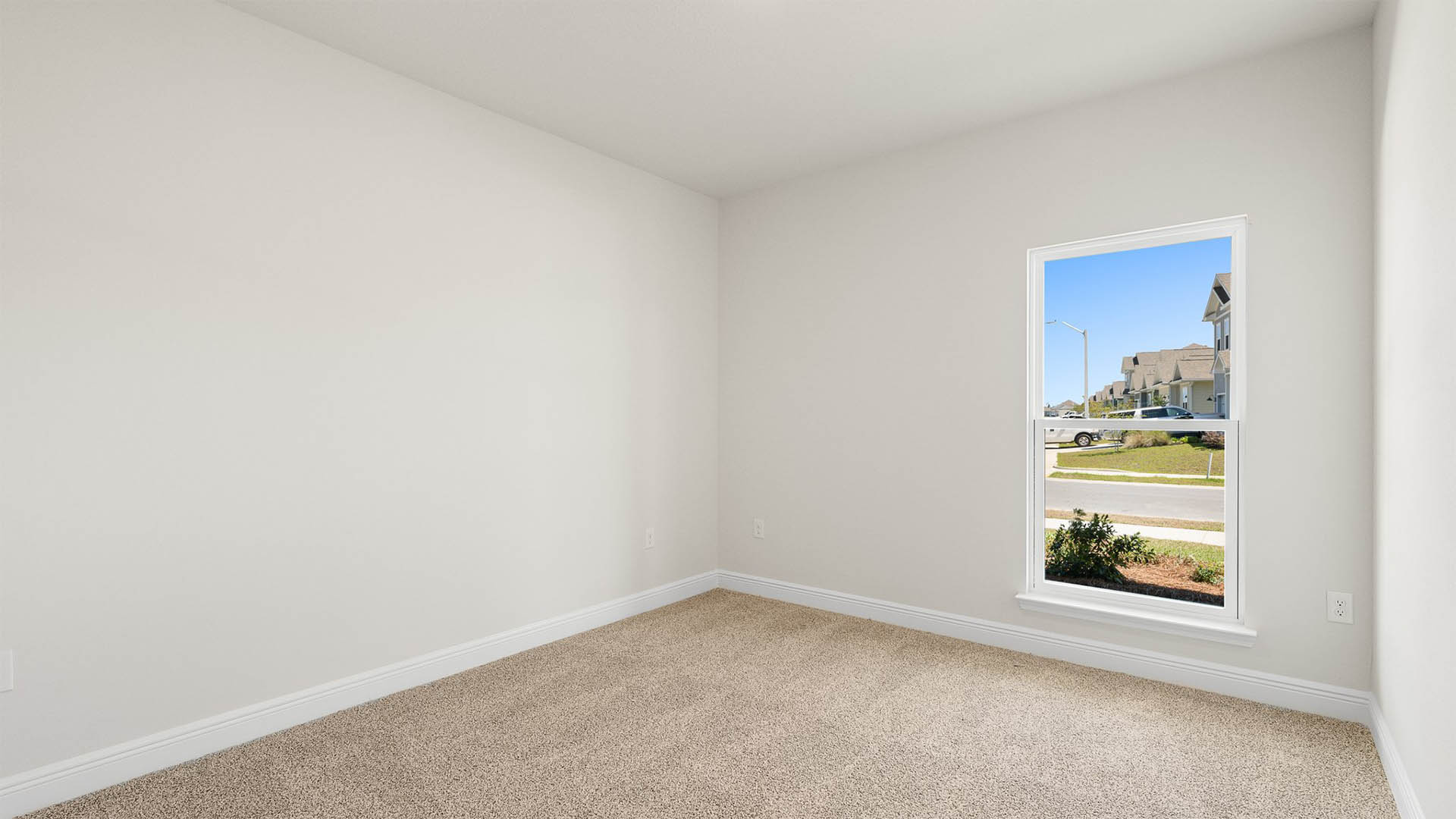 Bedroom with carpet floors and window.