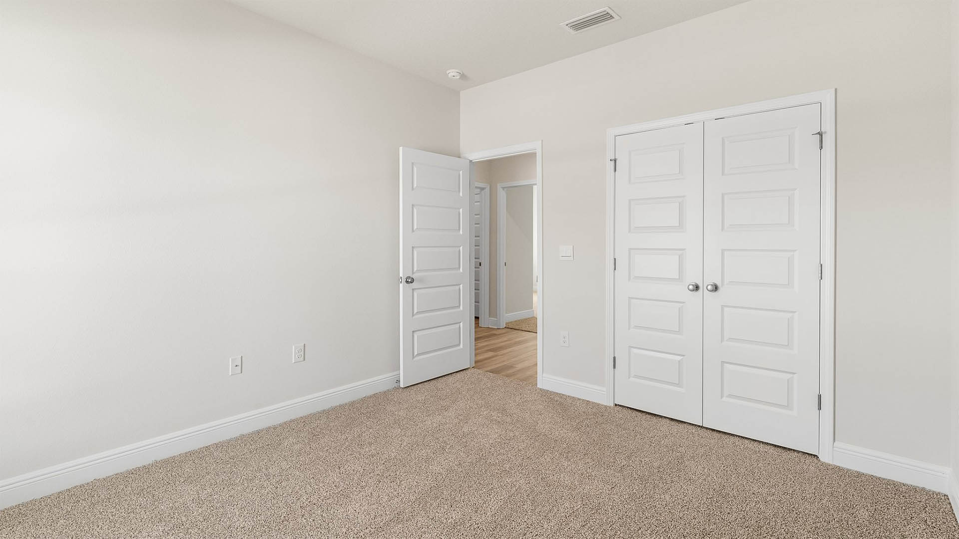 Bedroom with carpet floors and closet.