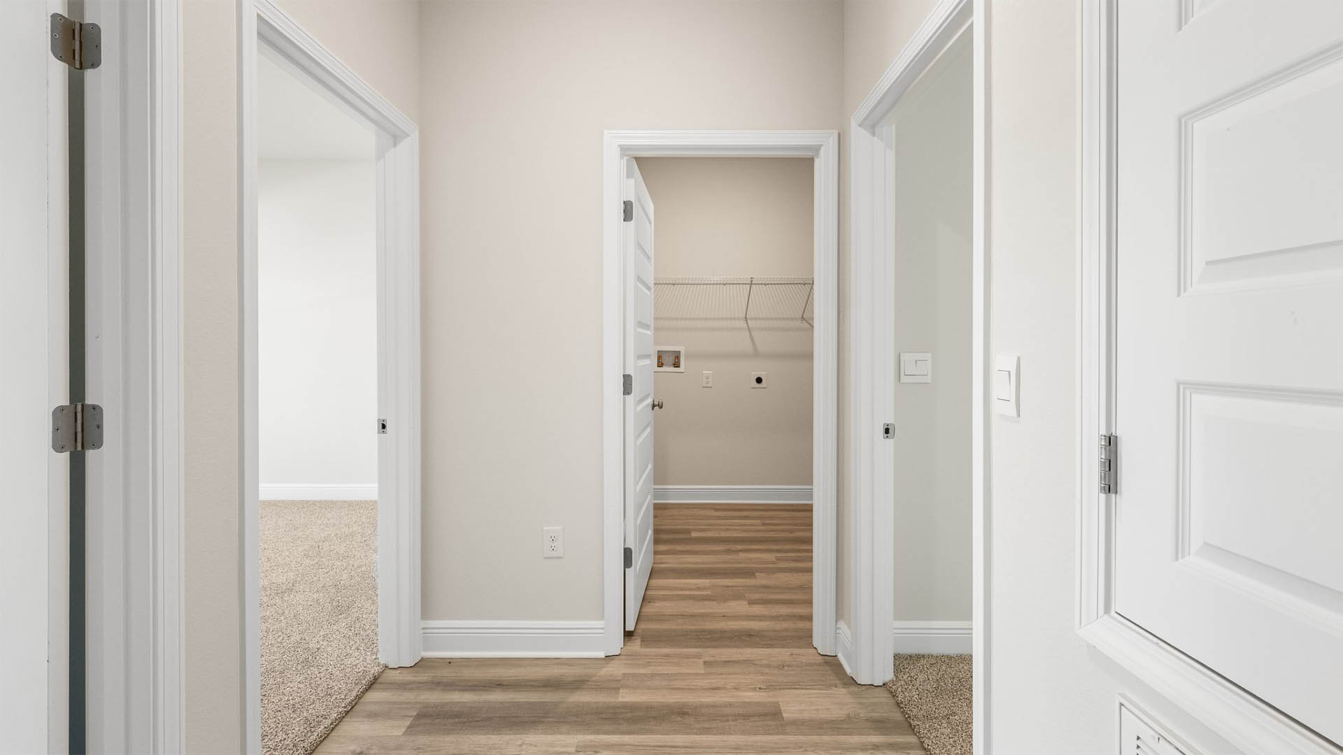 Side hallway with bedrooms and laundry room.