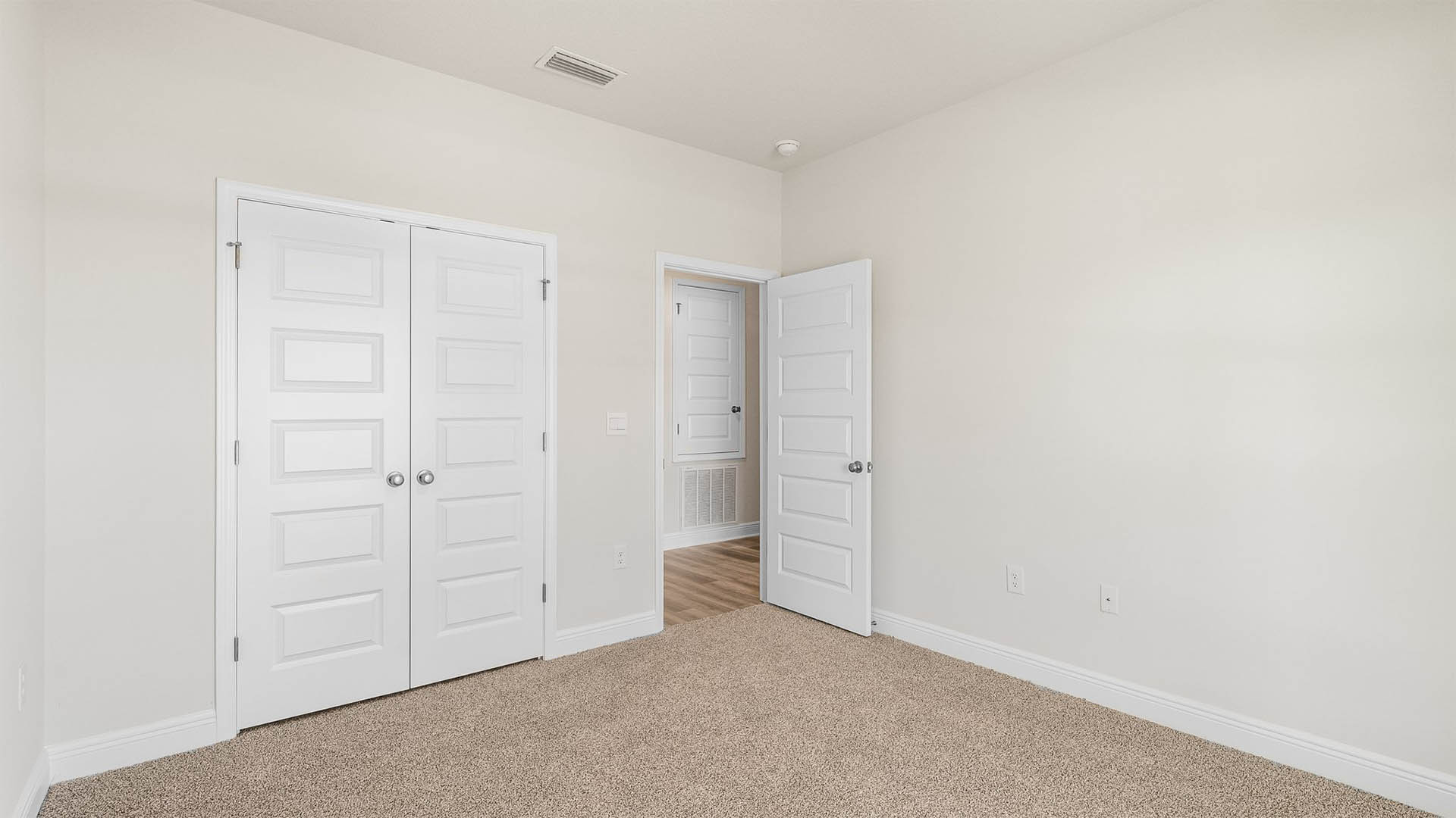 Bedroom with carpet floors and closet.
