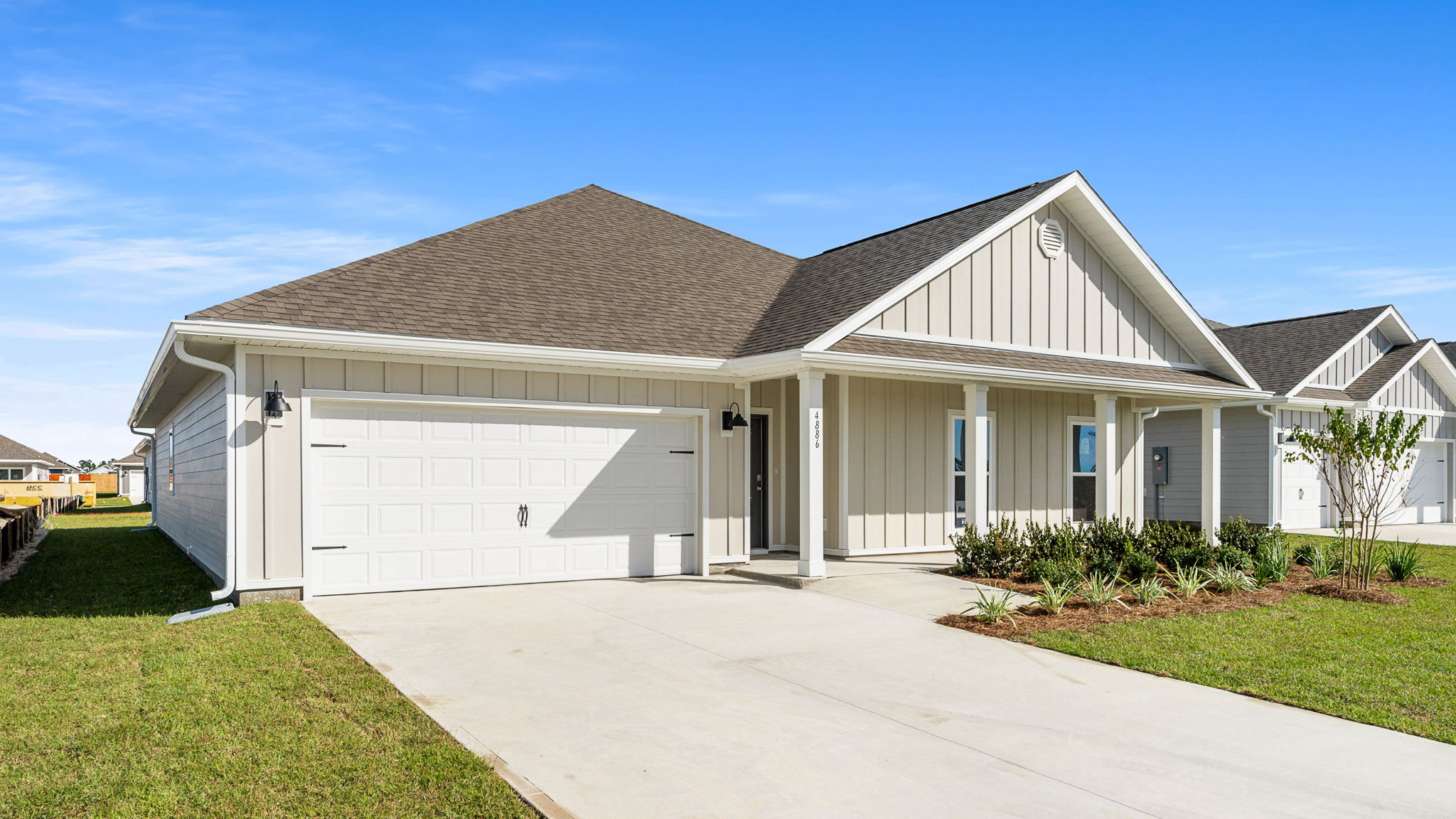 Victoria floor plan at Titus Park front of home with covered front porch and two-car garage and Hardie siding.