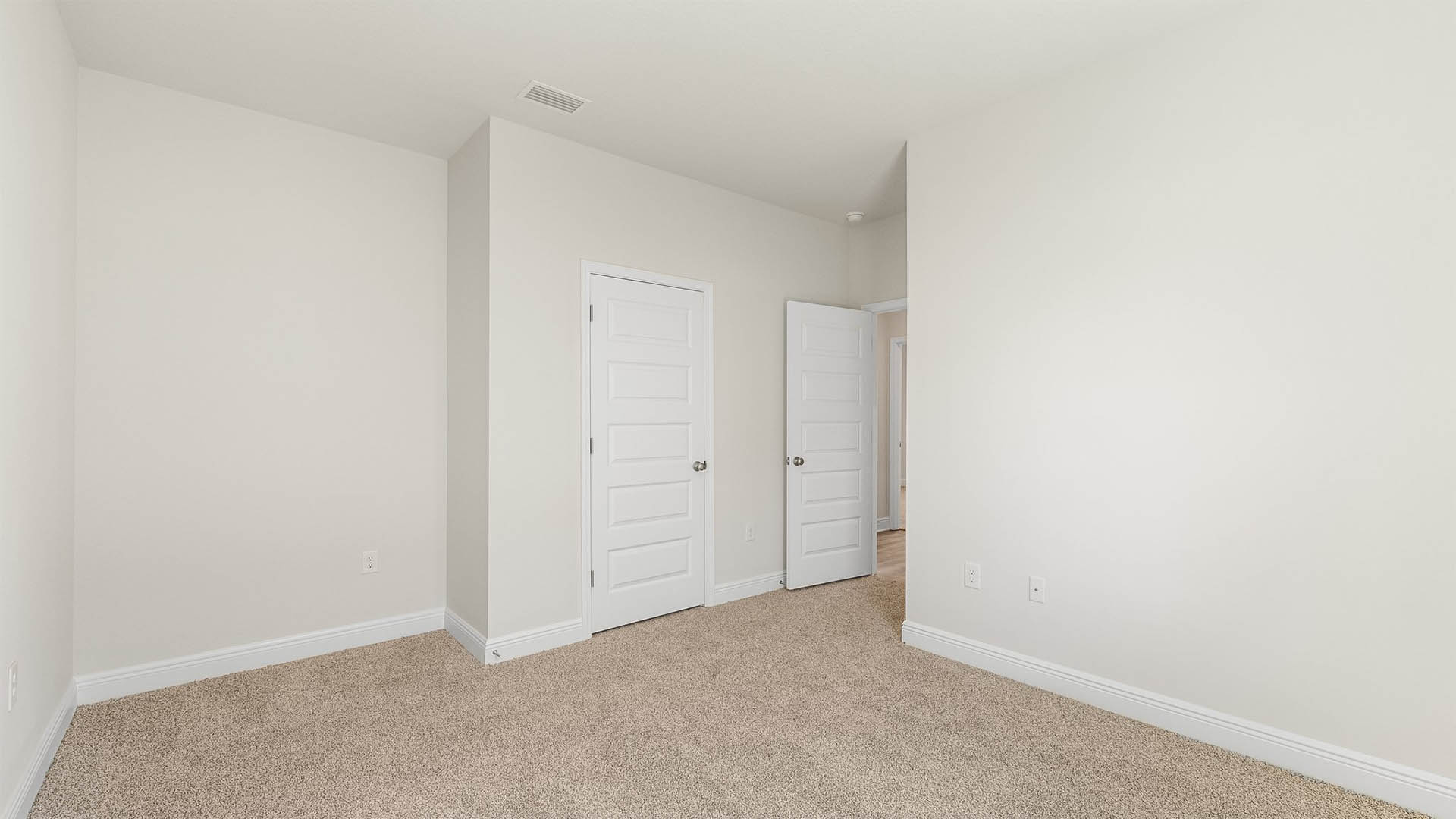 Bedroom with carpet floors and closet.
