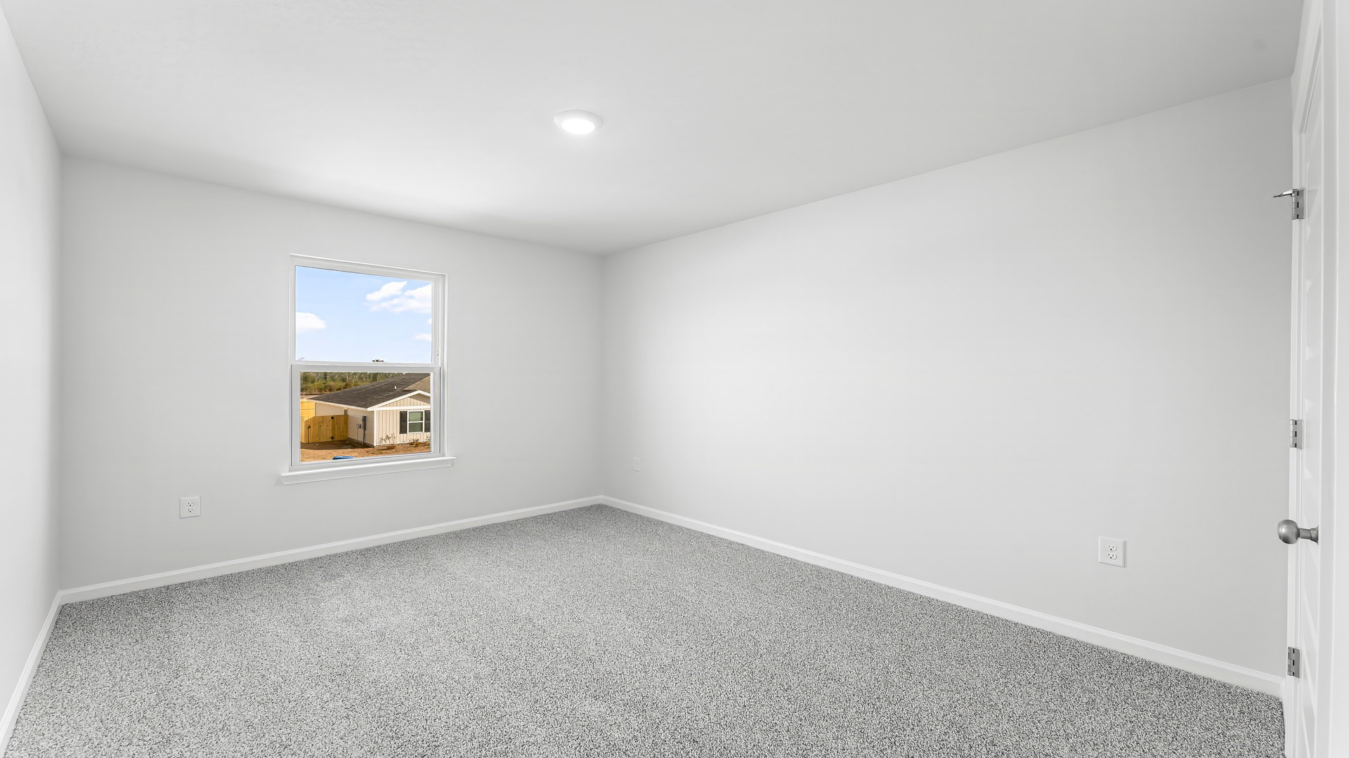 Bedroom with carpet floor and window.