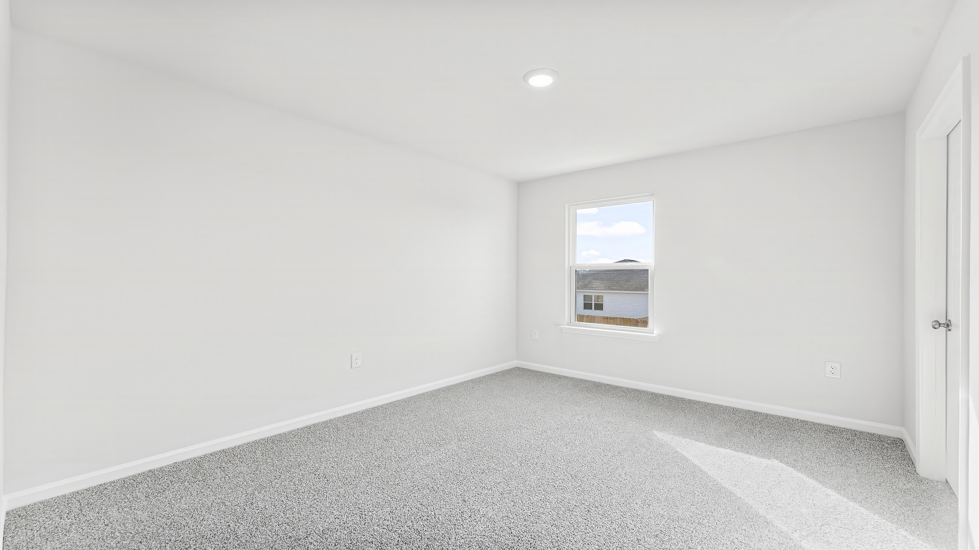 Bedroom with carpet floor and window.