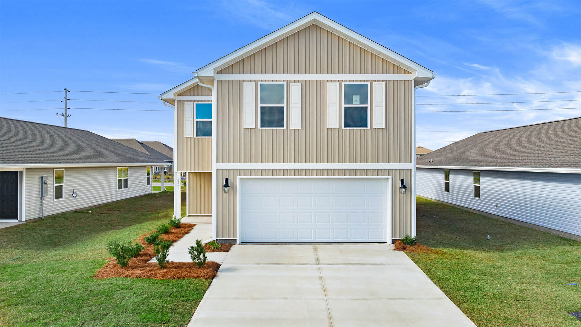 Aisle plan front of home with vinyl siding and two-car garage.