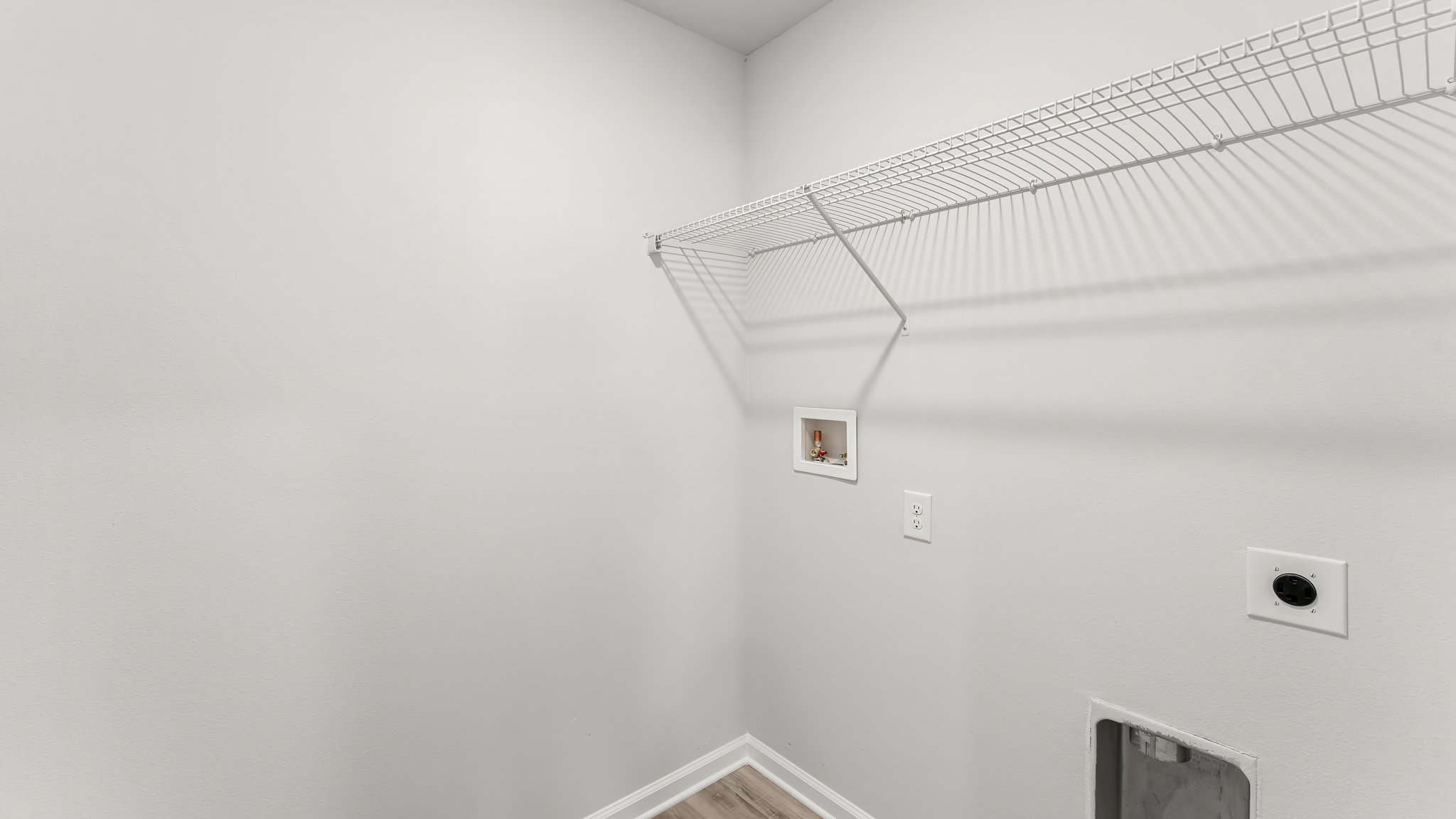 Laundry room with EVP flooring and ventilated shelving.