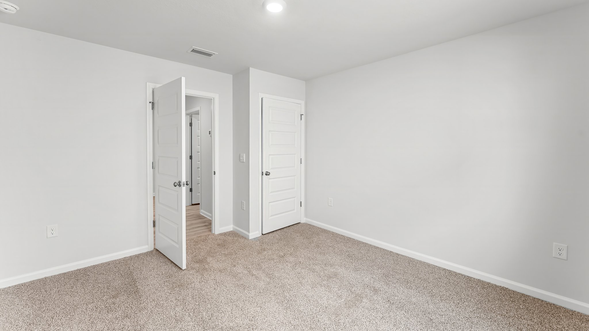 Bedroom with carpet flooring and closet.