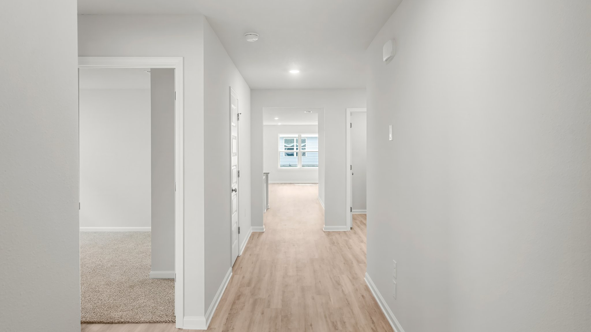 Front hallway by front door and bathroom and 2 bedrooms with EVP flooring.