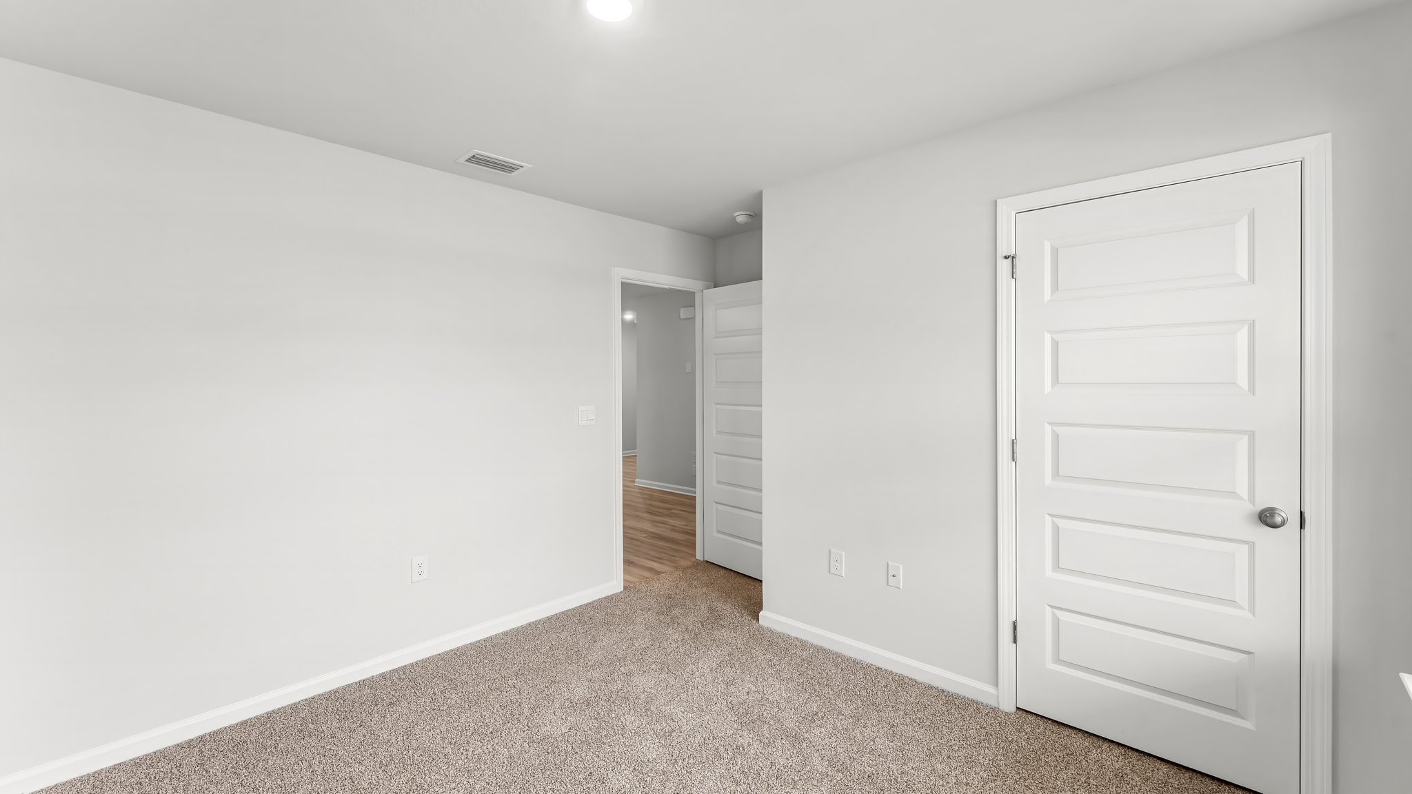 Bedroom with carpet flooring and closet.