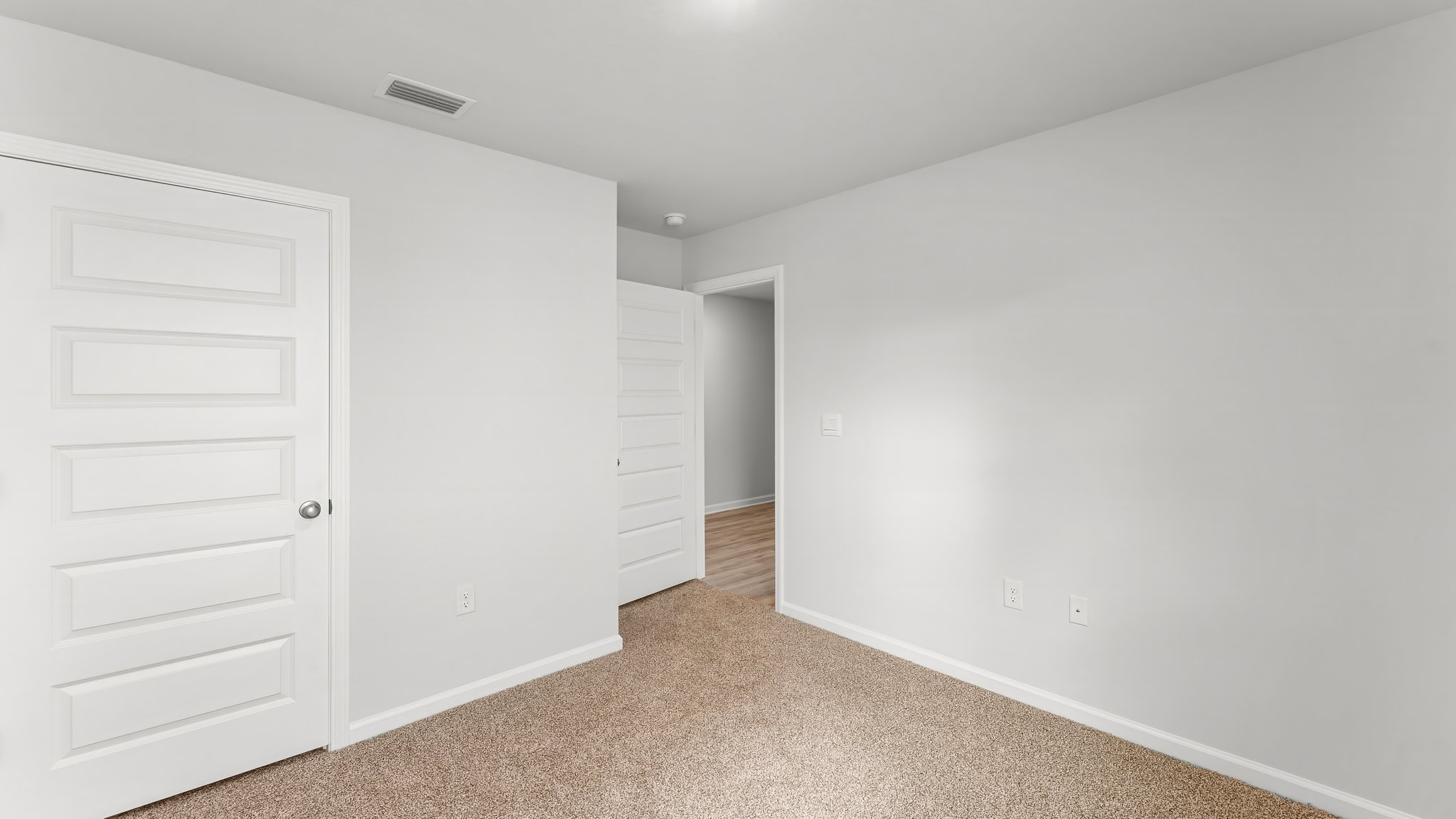 Bedroom with carpet flooring and closet.