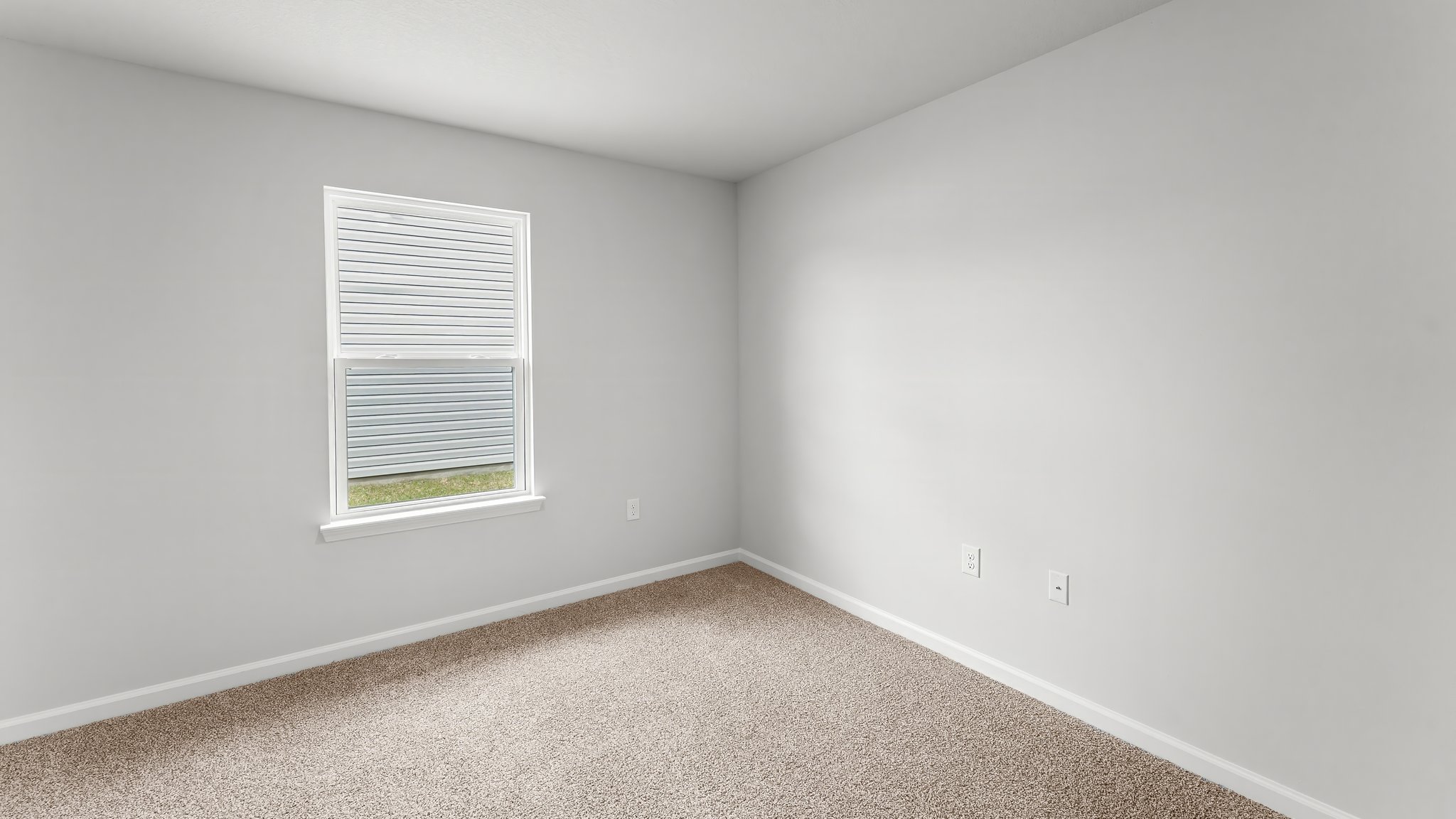 Bedroom with carpet flooring and window.