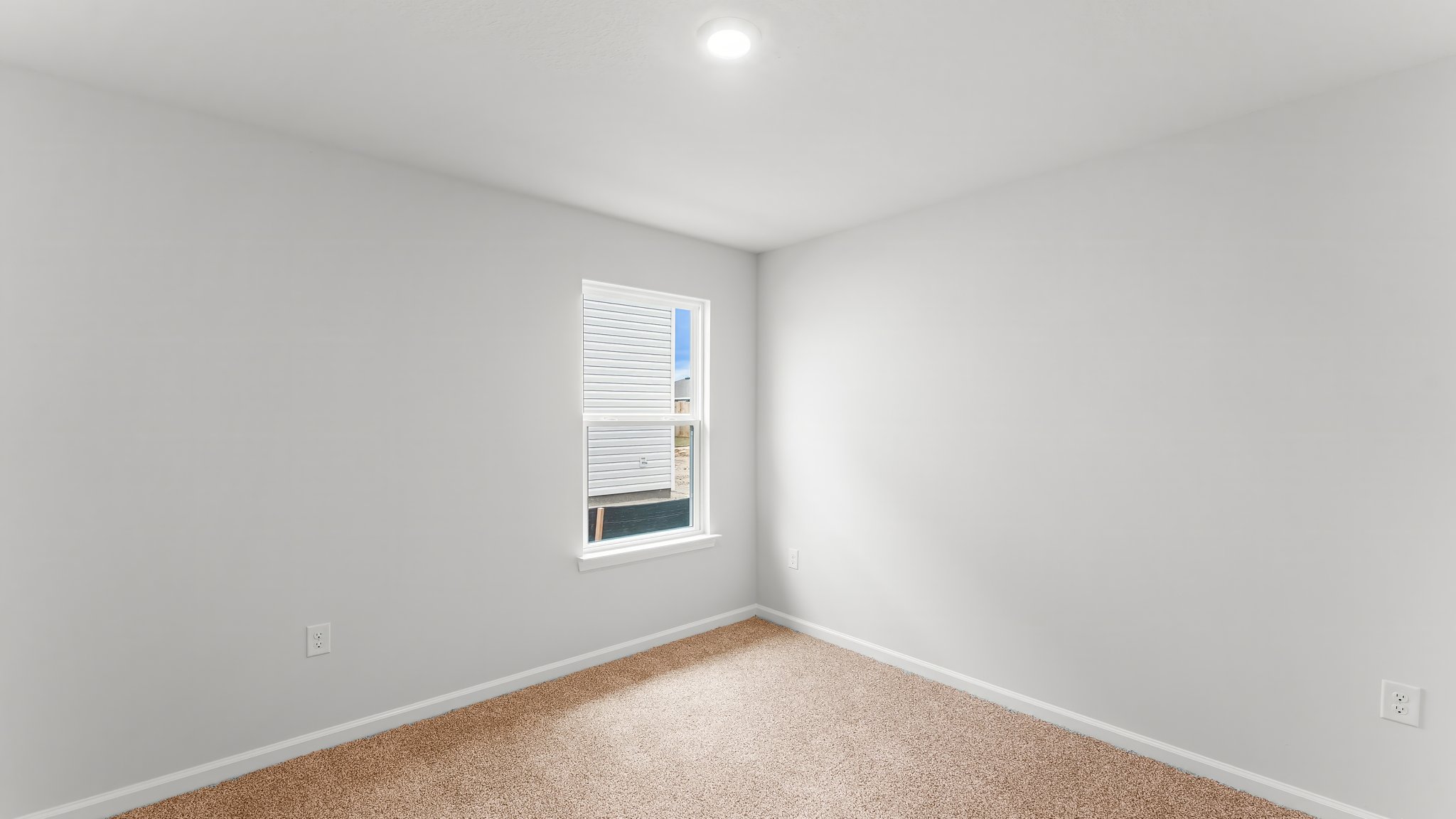 Bedroom with carpet flooring and window.