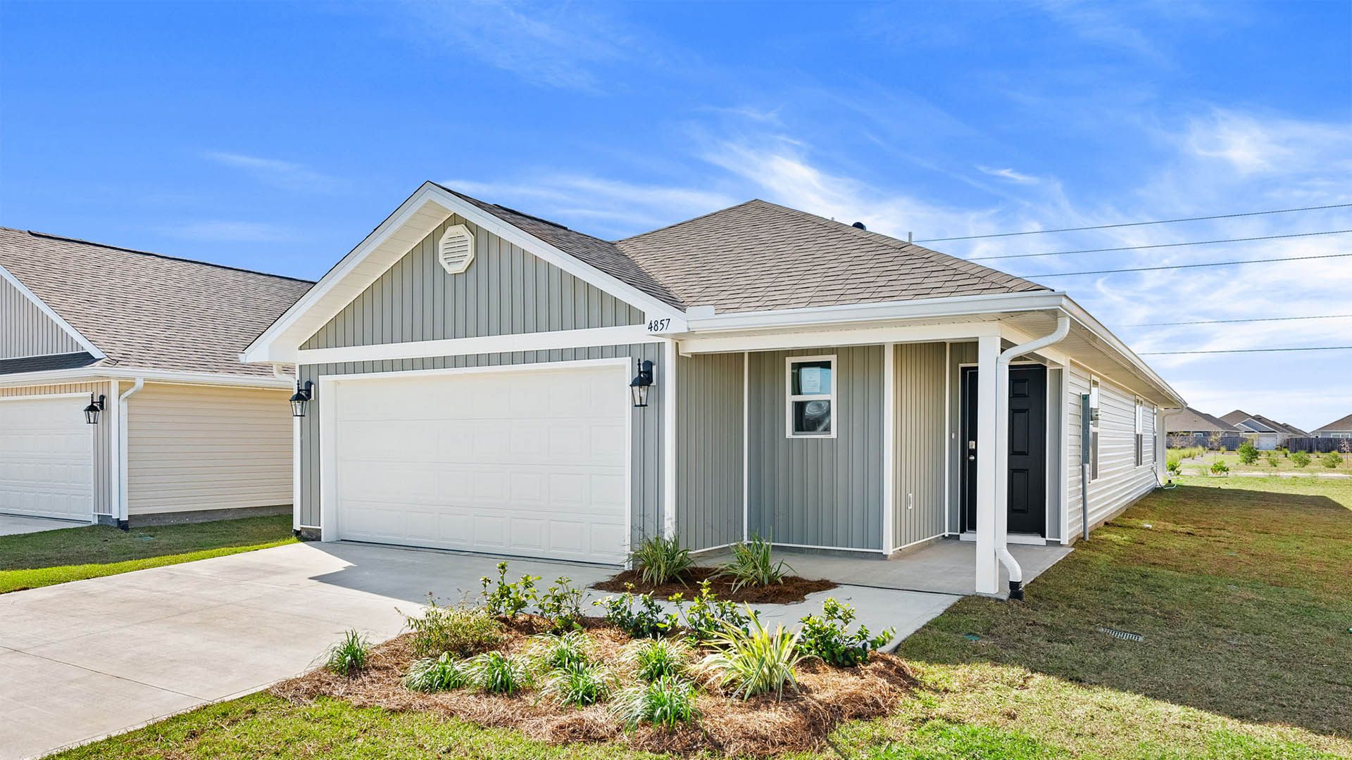The Jemison floor plan at Titus Park with two car garage and covered front porch and vinyl siding.