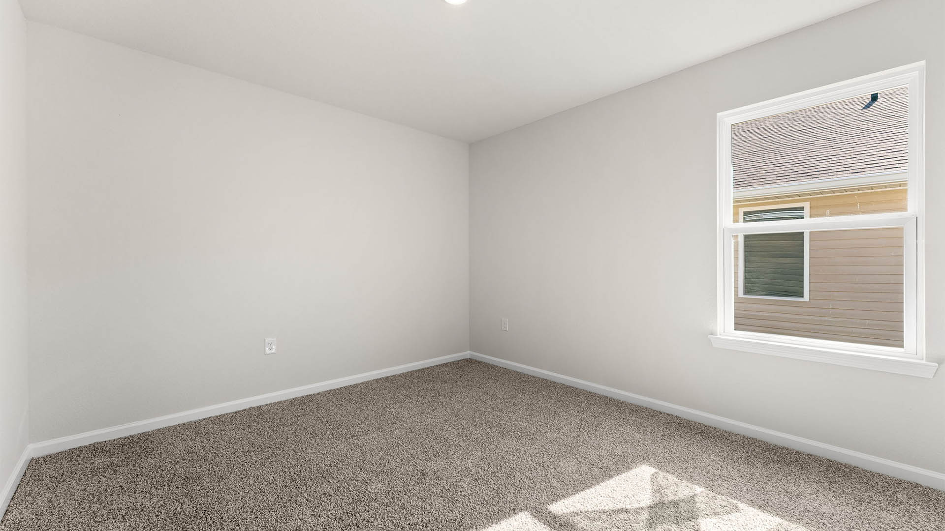 Bedroom with carpet floors and window.