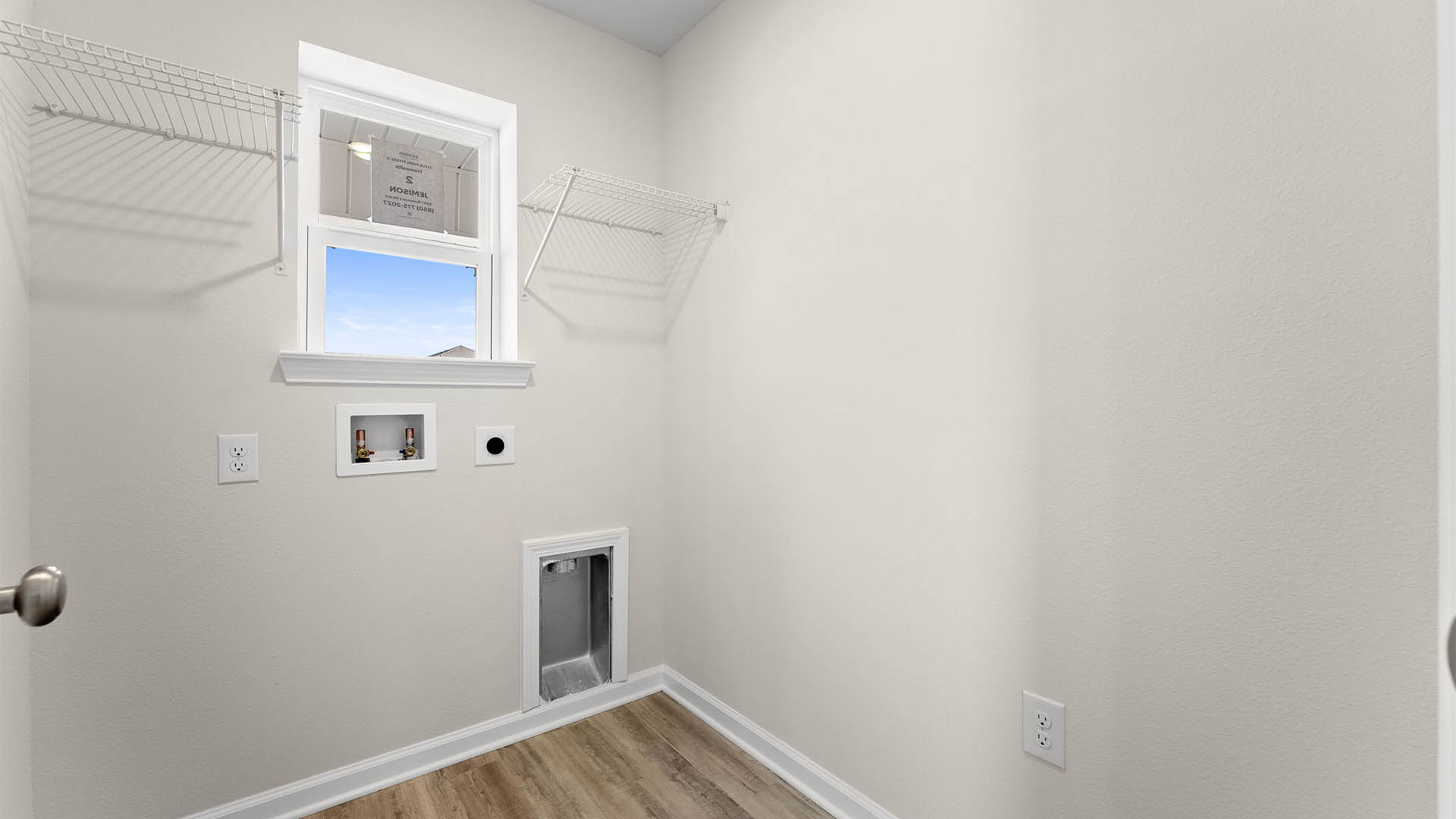 Laundry room with EVP flooring and window and ventilated shelving.