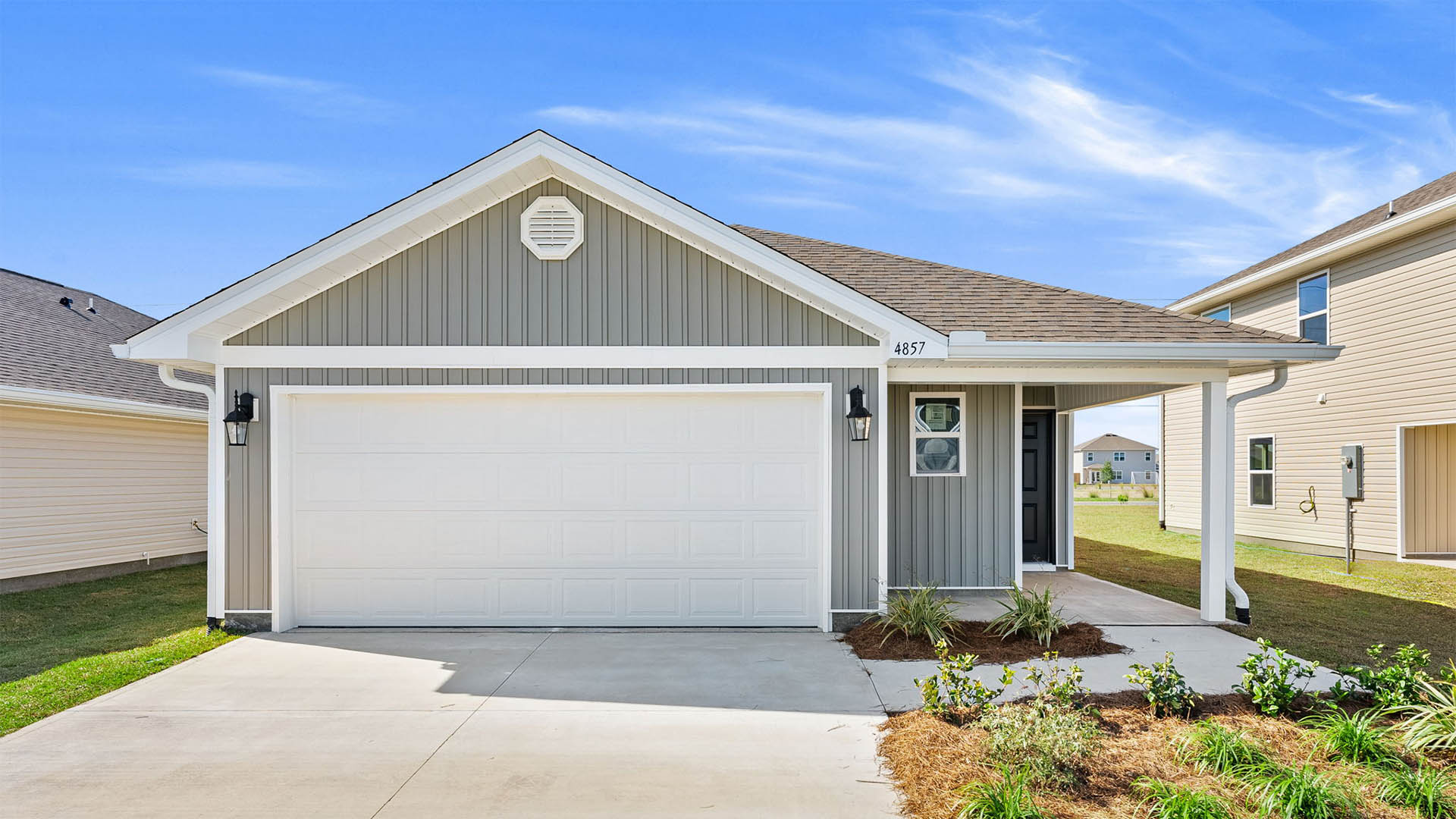 The Jemison floor plan at Titus Park with two car garage and covered front porch and vinyl siding.