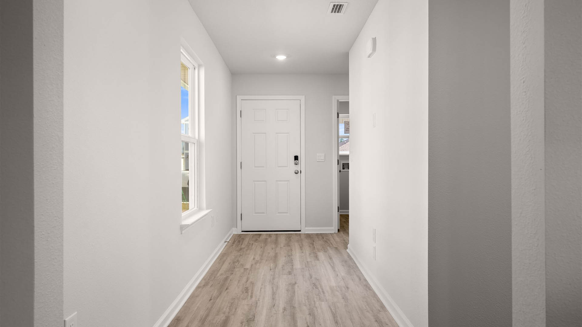 Front door entrance hallway with EVP flooring and hallway to bedrooms.