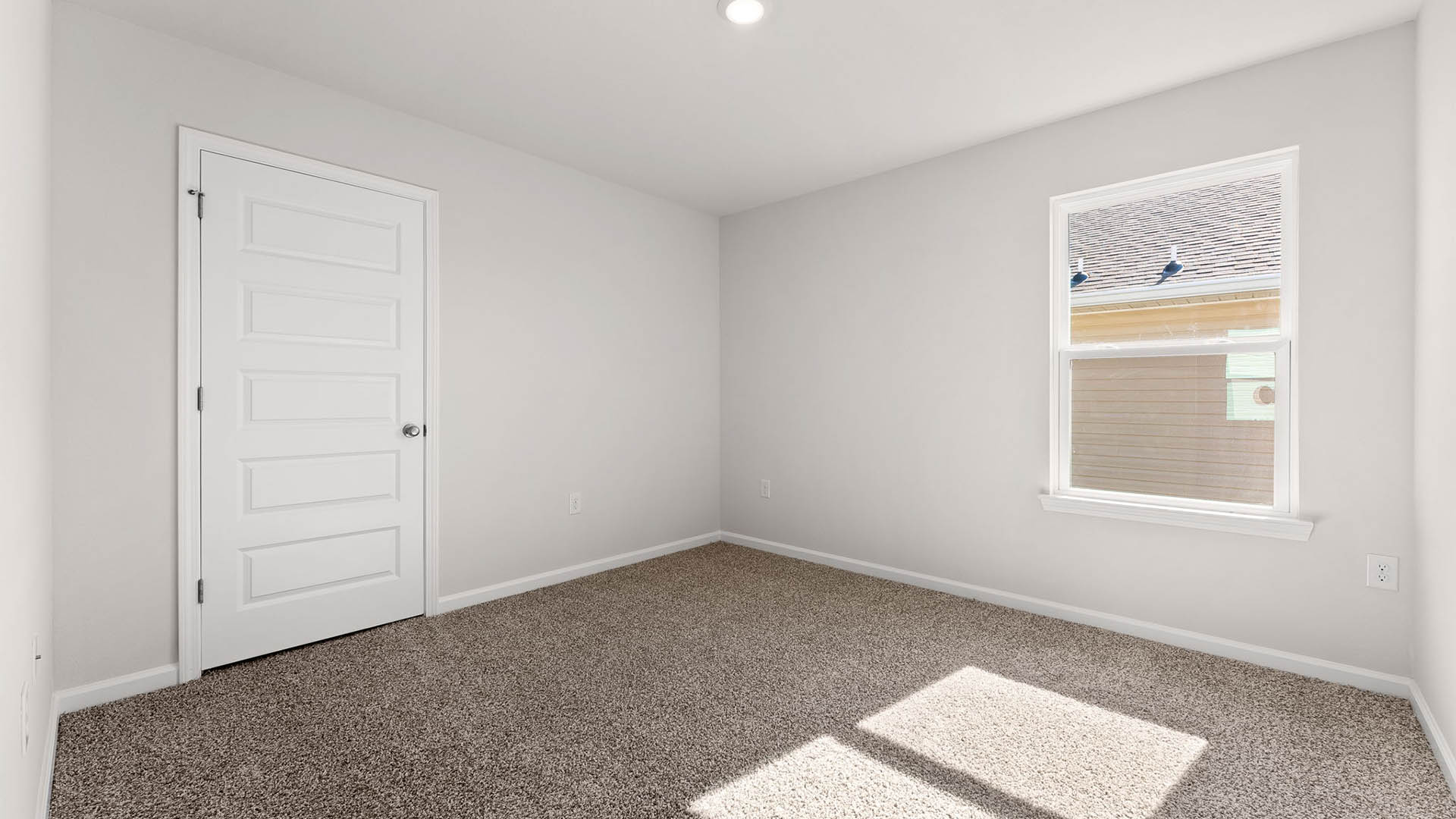 Bedroom with carpet floors and window.
