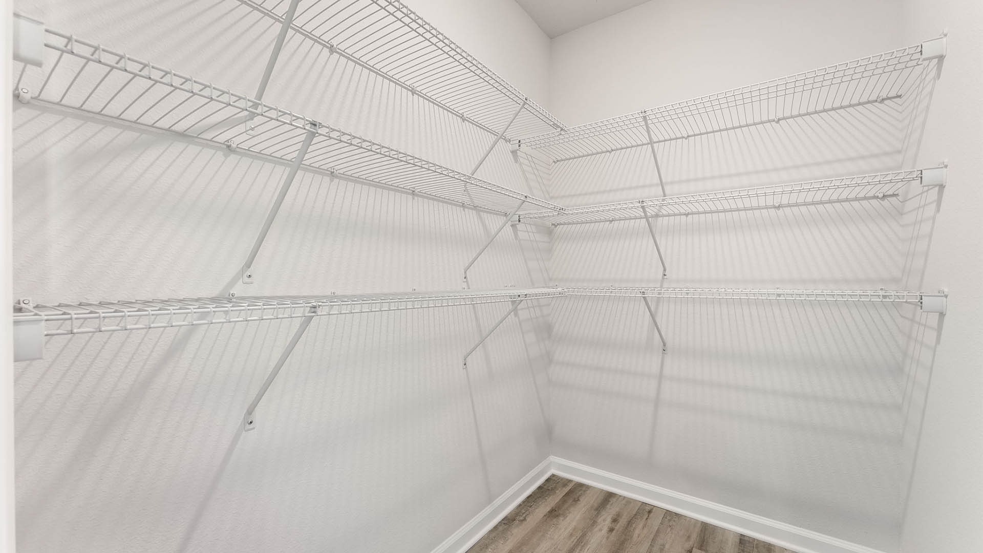 Kitchen pantry with EVP flooring and ventilated shelving.