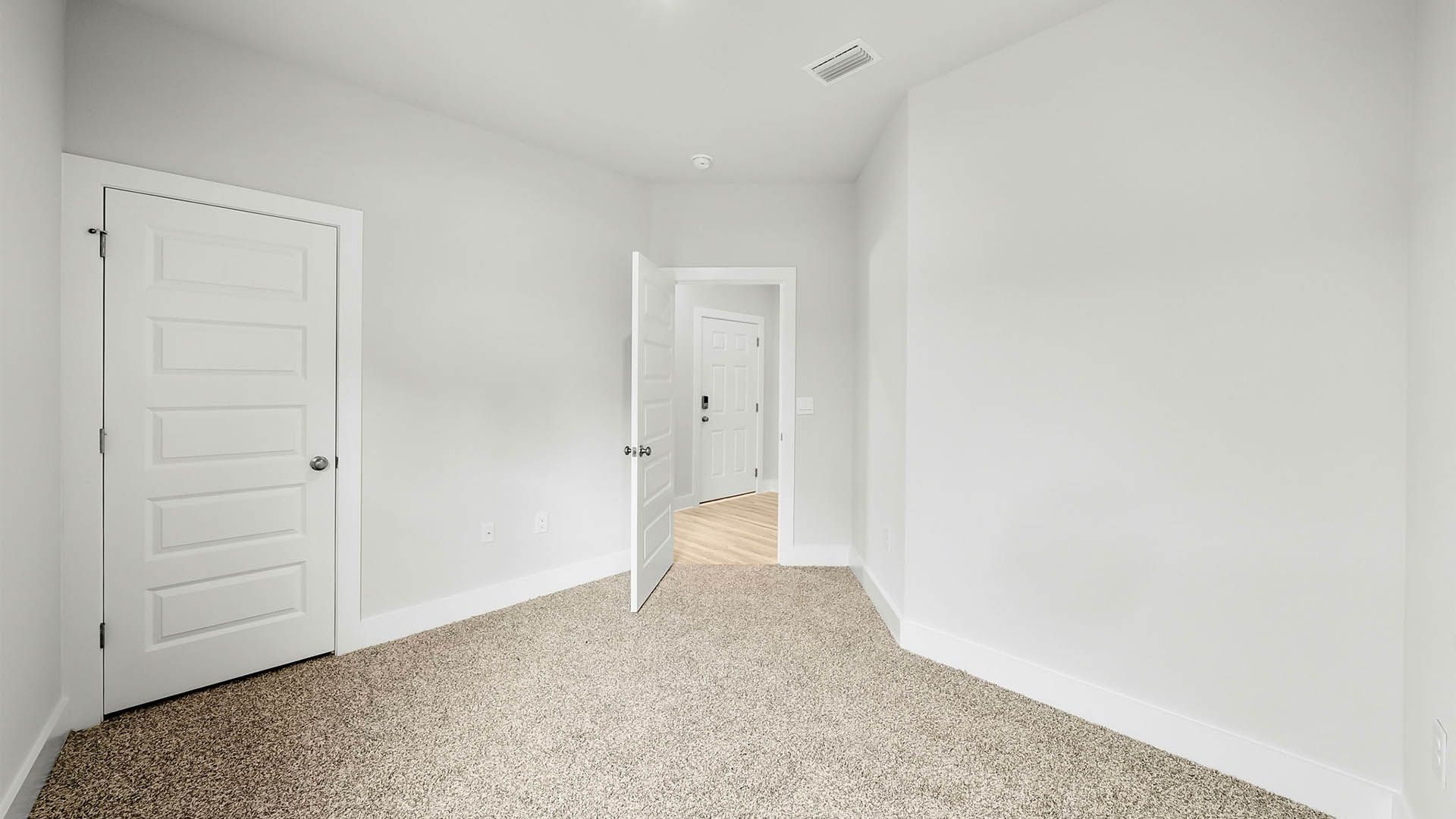Bedroom with carpet flooring and closet.