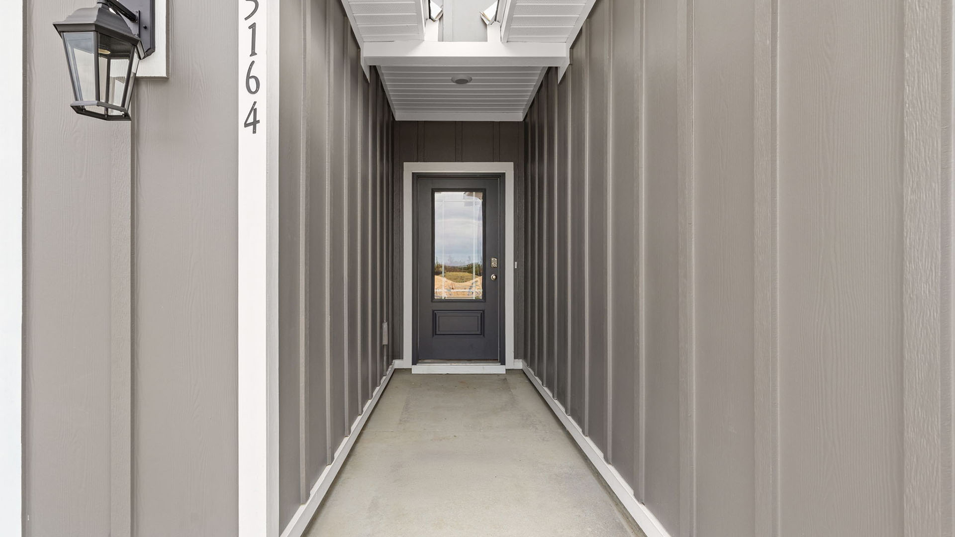 Covered front entrance prairie style front door.