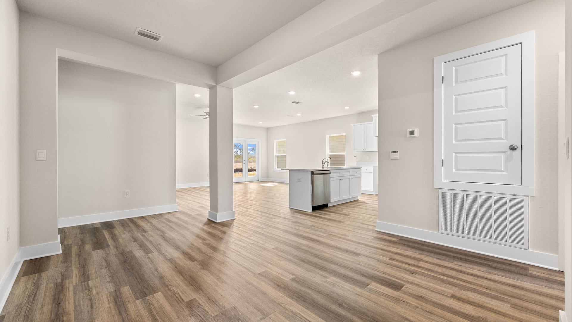Dining room with EVP flooring and kitchen.