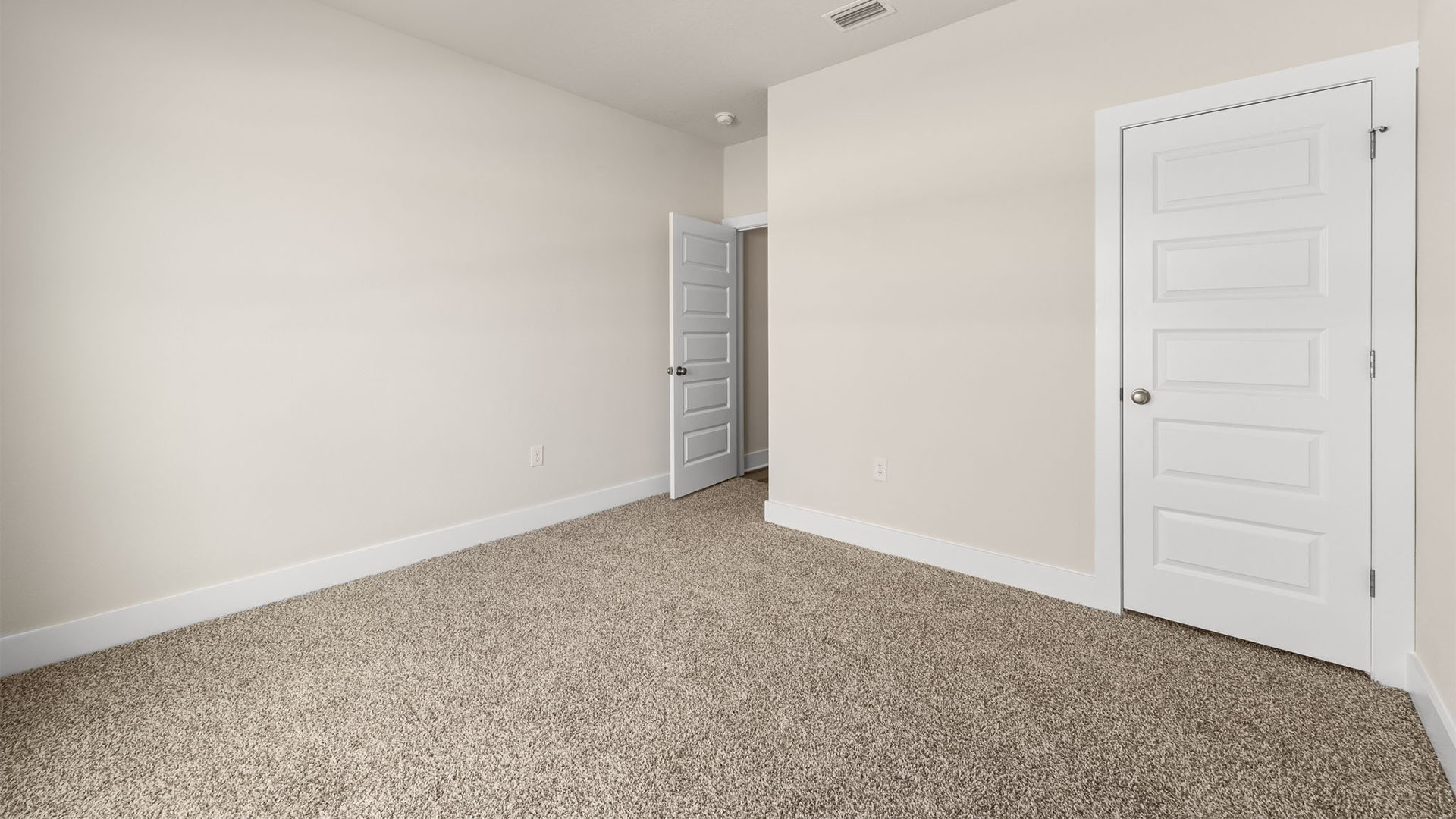 Bedroom with carpet flooring and closet.